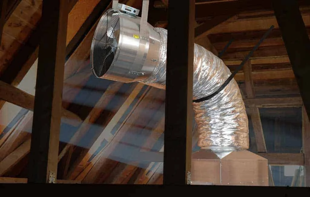 whole house fan installed in attic with ductwork for home ventilation and long term cooling system performance