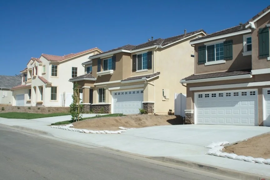 Row of Southern California stucco tract homes representative of the 1970s and 1980s construction found throughout Fullerton, where aging HVAC systems, deteriorated ductwork, and outdated insulation are common problems for Orange County homeowners
