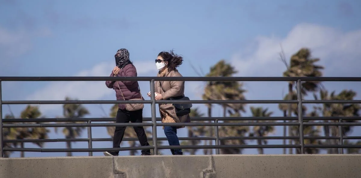 People wearing masks outdoors during poor air quality conditions, highlighting the need for effective HVAC air filters indoors