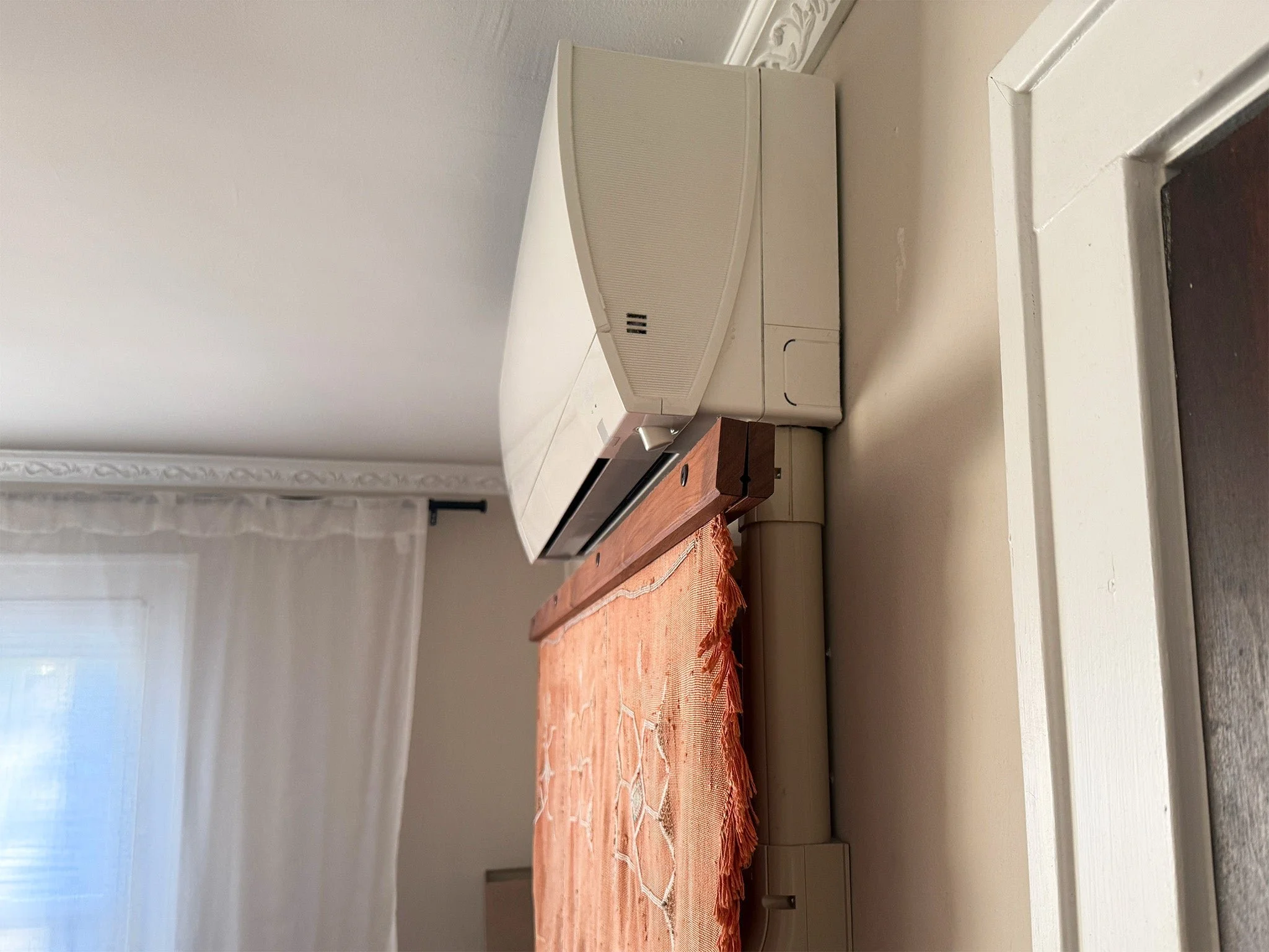 Mitsubishi ductless mini-split indoor air handler mounted on a wall in an Orange County home