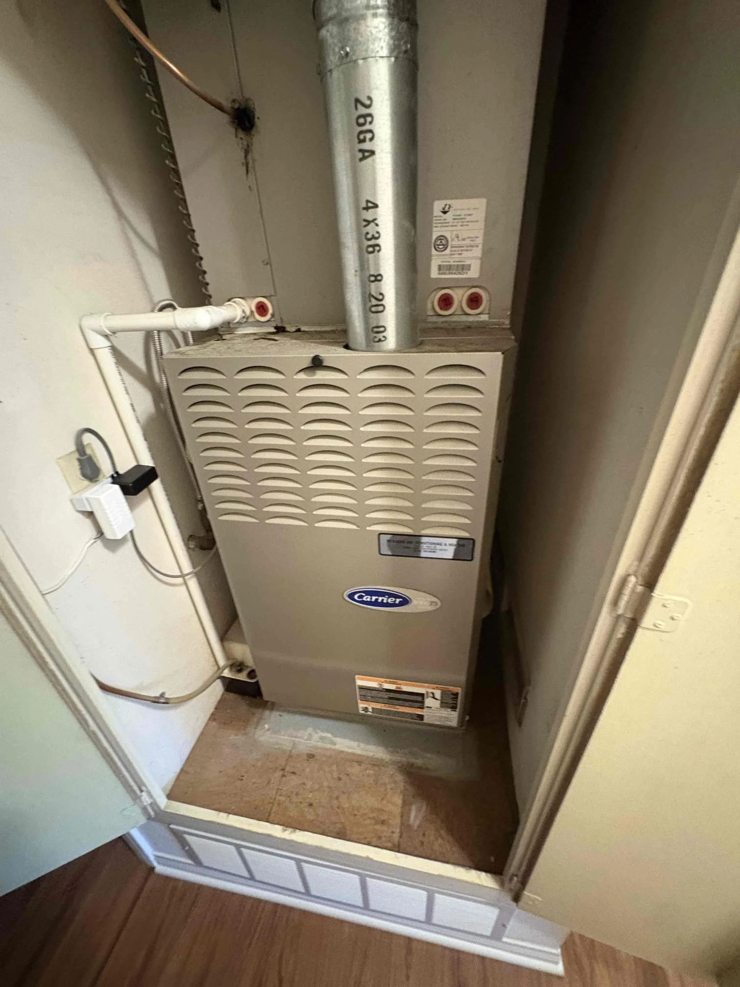 whole-home humidifier installed on Carrier furnace with ductwork integration showing professional HVAC installation in Orange County home closet