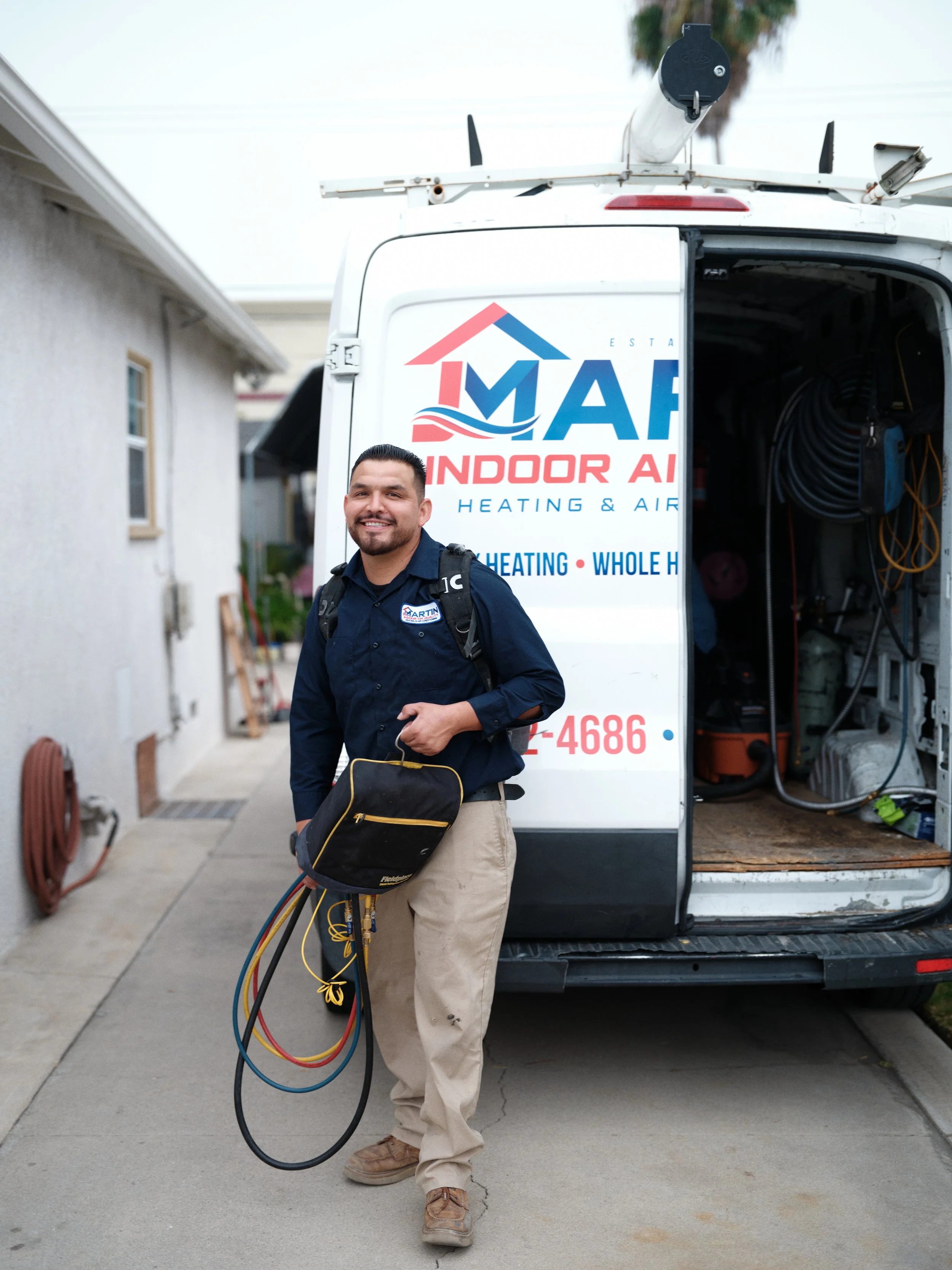 J Martin HVAC technician with equipment at Orange County home for AC repair service
