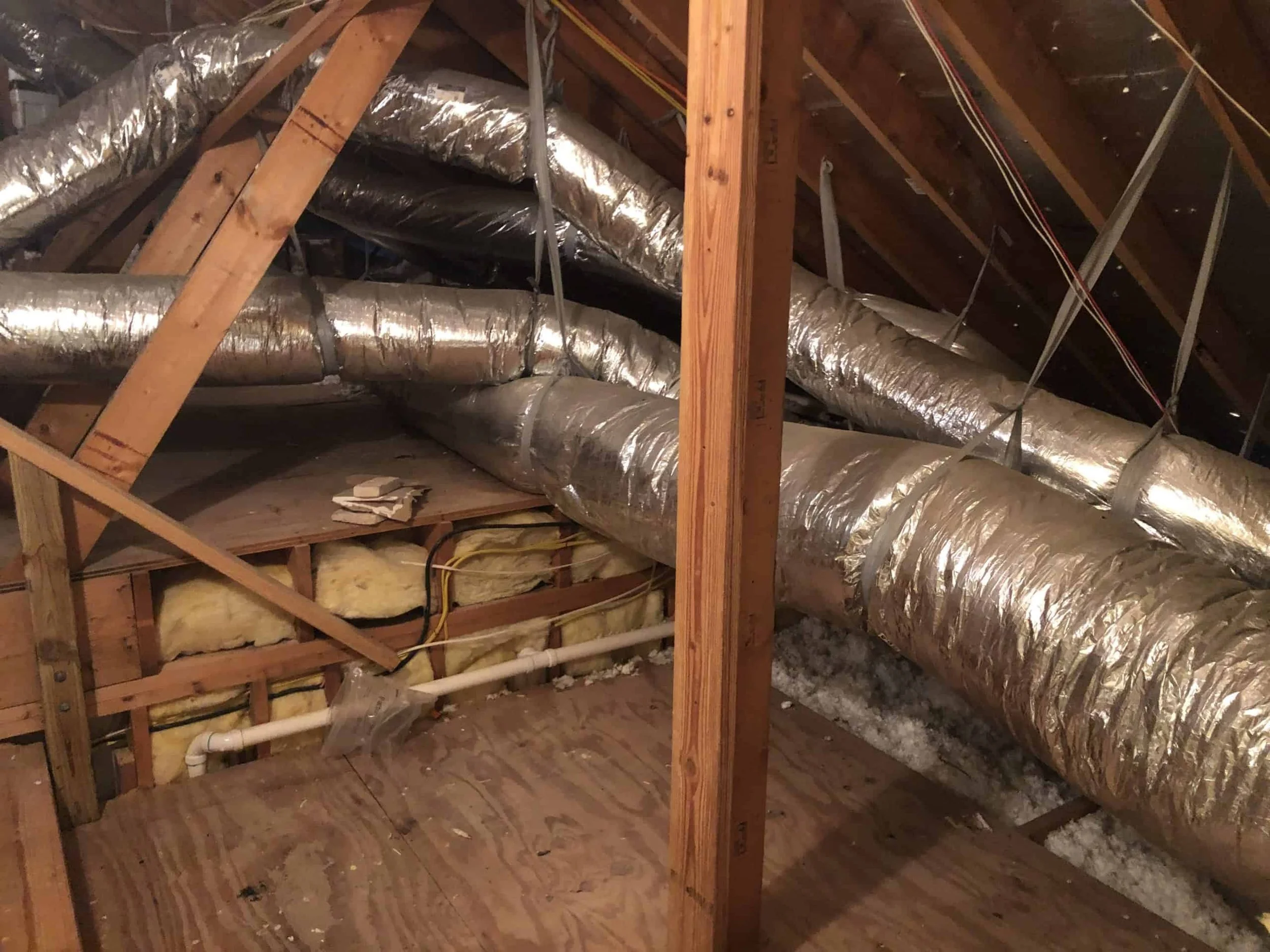 aging flexible ductwork running through a residential attic in a Yorba Linda home