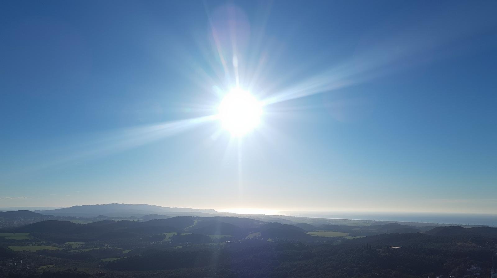 Bright sunny day with clear blue skies over Southern California hills and coastline, ideal weather conditions for cleaning outdoor HVAC condenser units