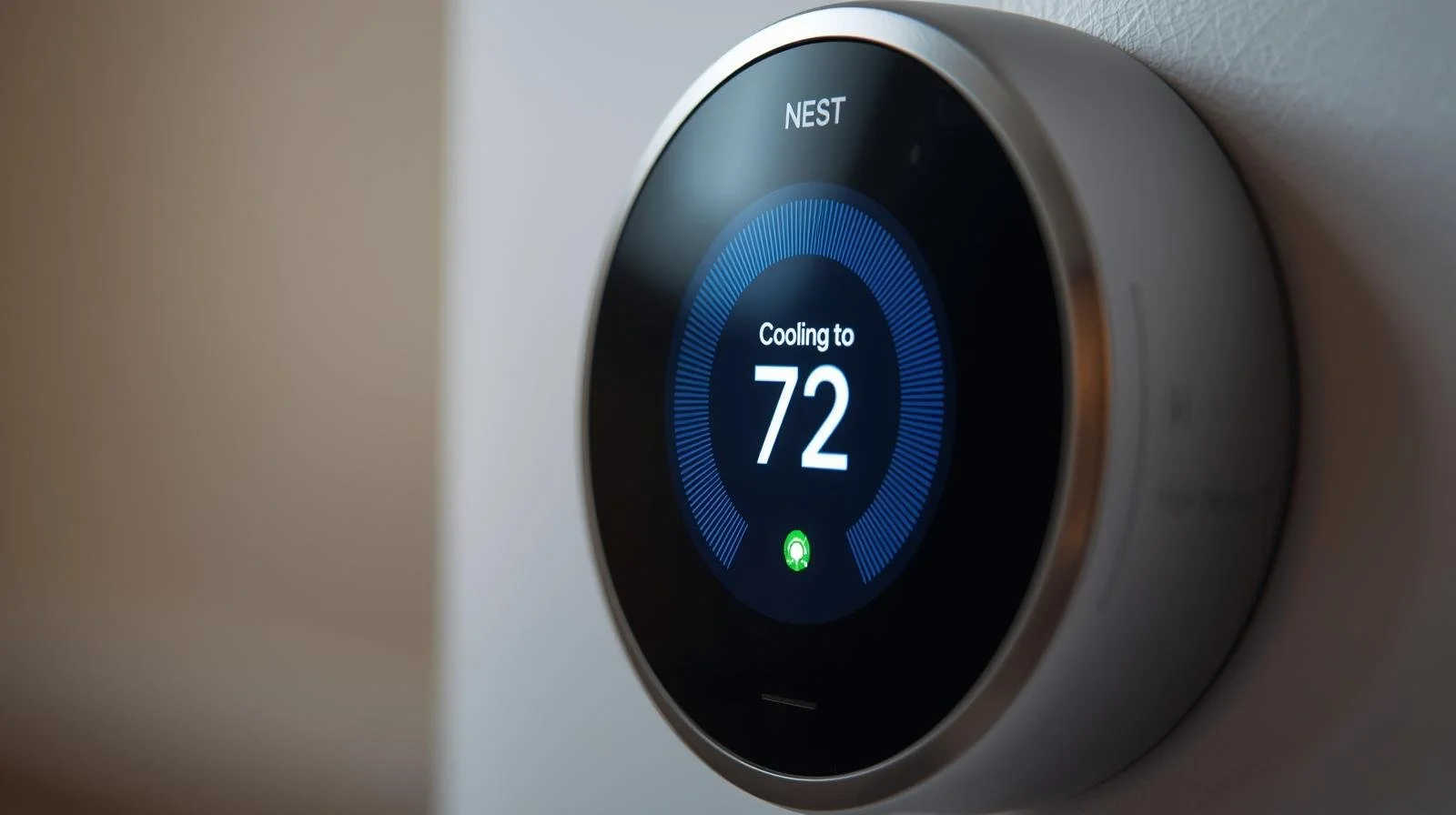 Nest smart thermostat displaying active cooling mode to 72 degrees for energy-efficient air conditioning in Orange County home