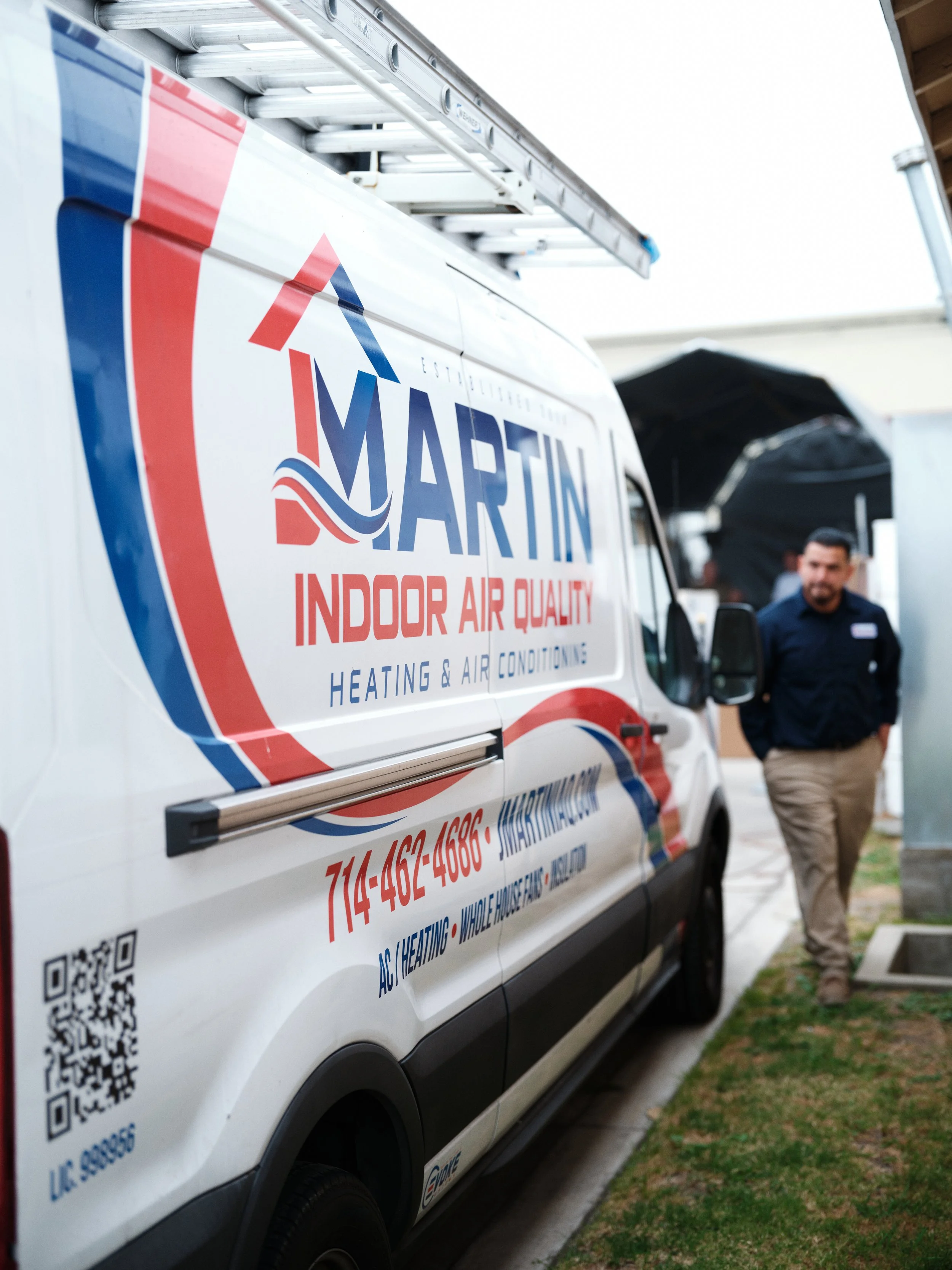 J Martin HVAC service van with technician arriving for residential air conditioning service in Orange County