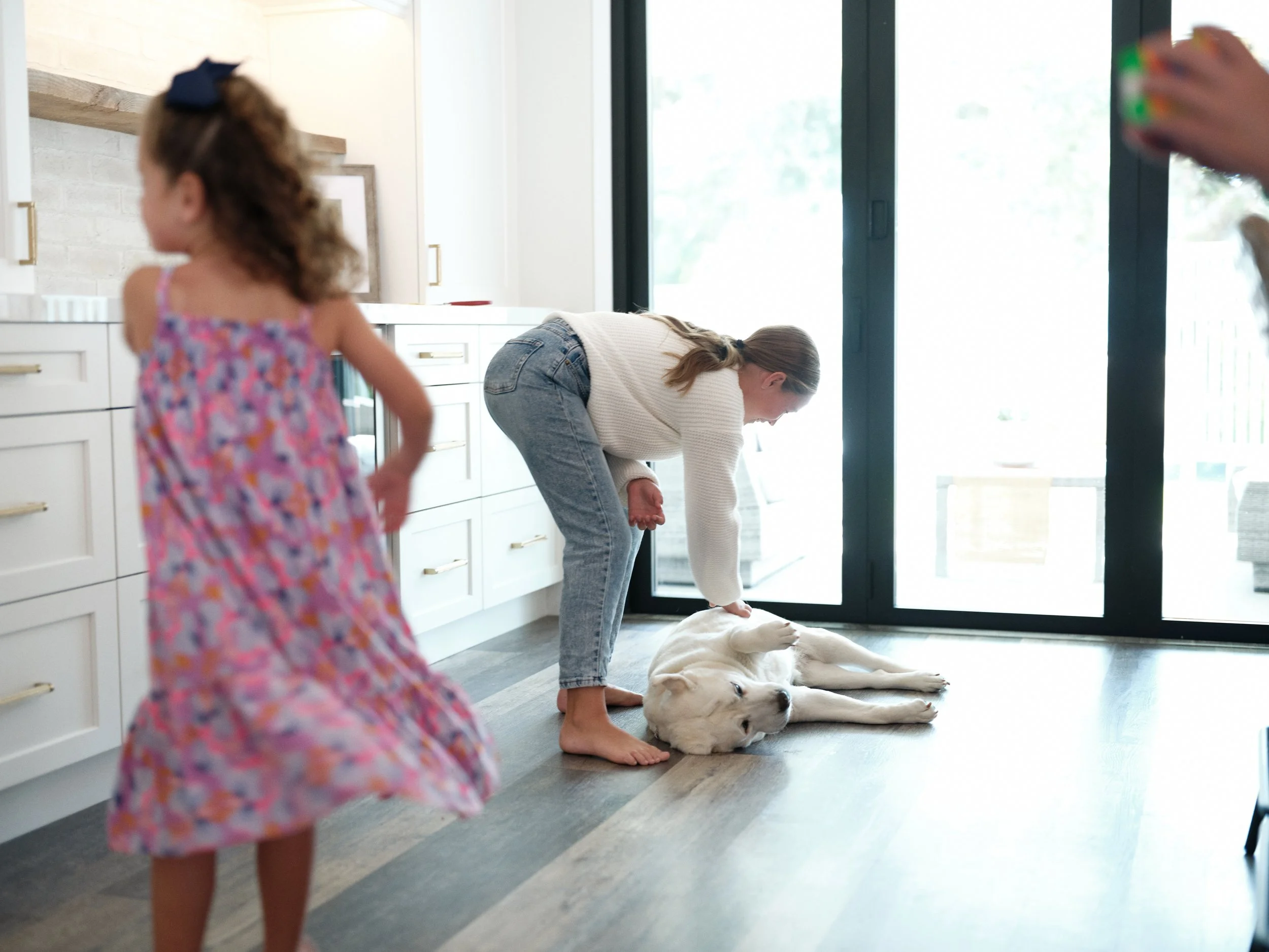 mother and children with dog in a clean home, representing healthy indoor air quality for allergy relief