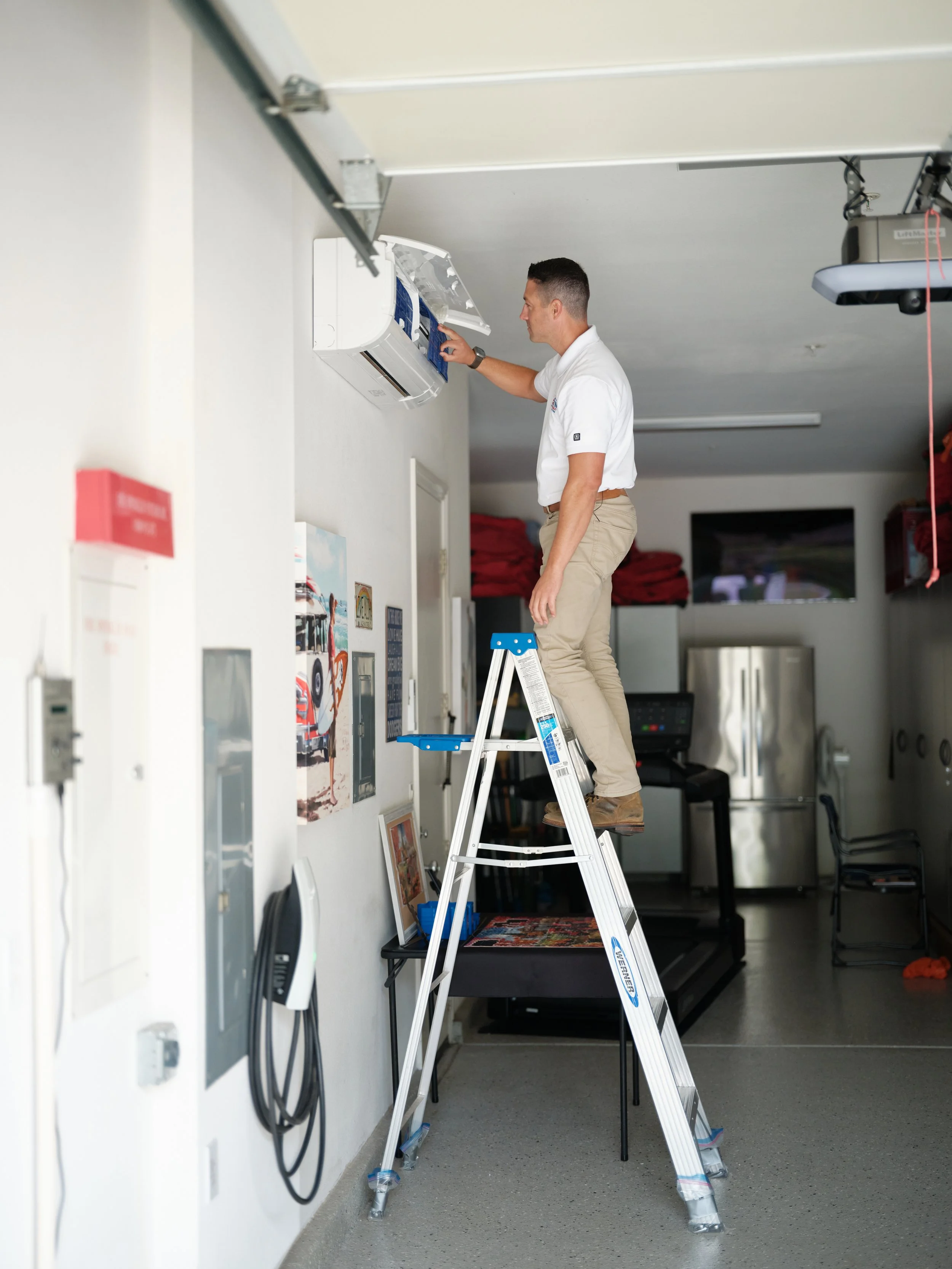 HVAC technician installing mini-split heat pump in Orange County home garage