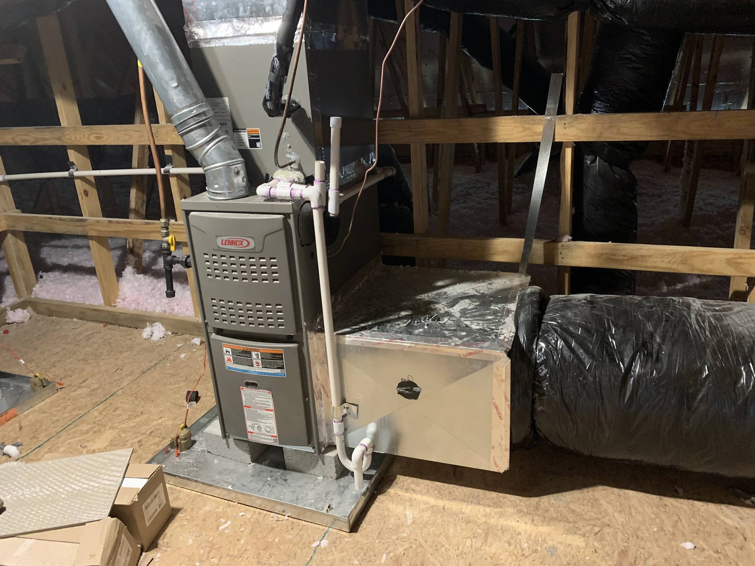 Lennox gas furnace and air handler installed in an Orange County attic with ductwork and condensate lines