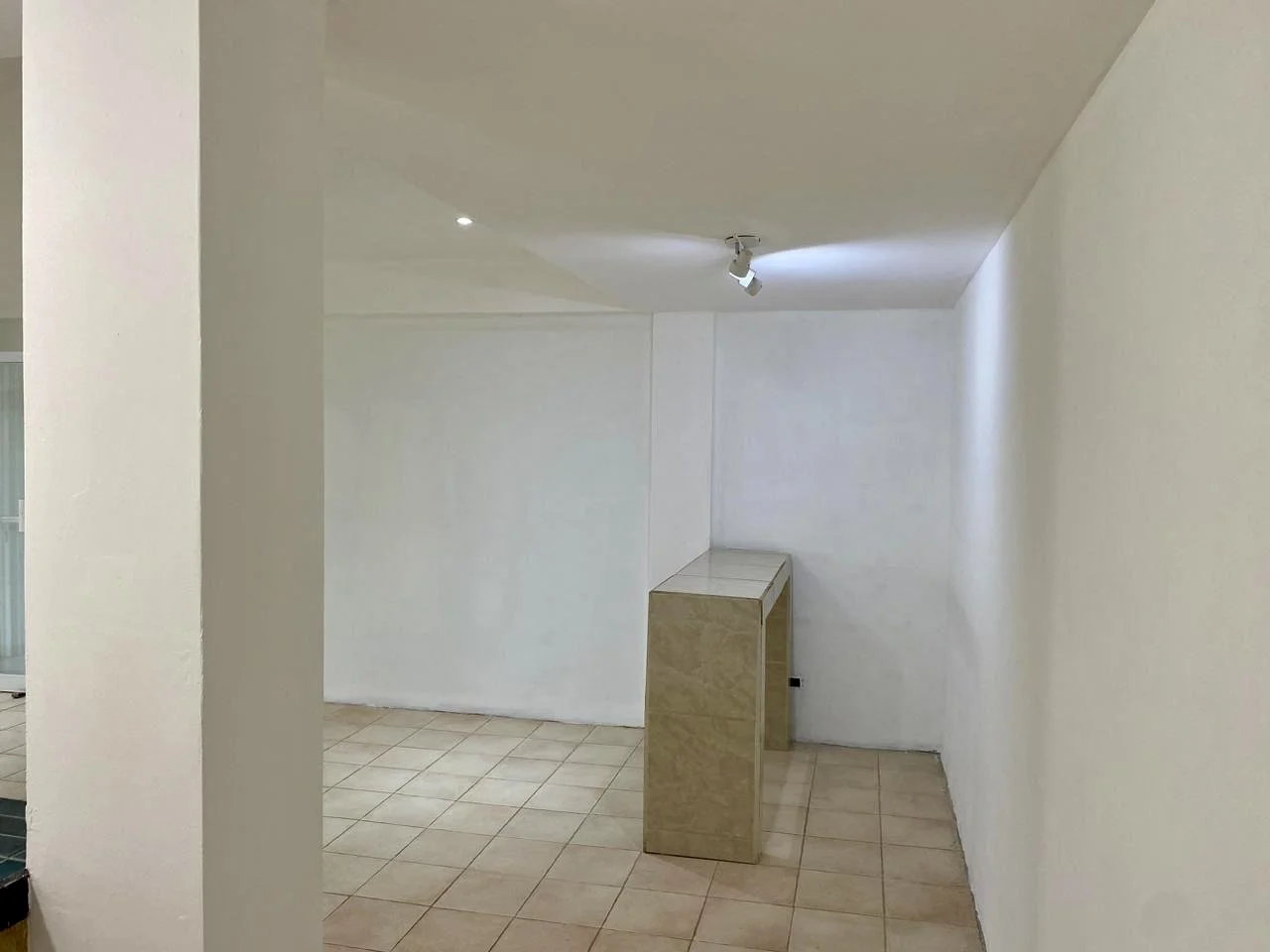 Open commercial retail interior with recessed ceiling lighting in Santa Teresa