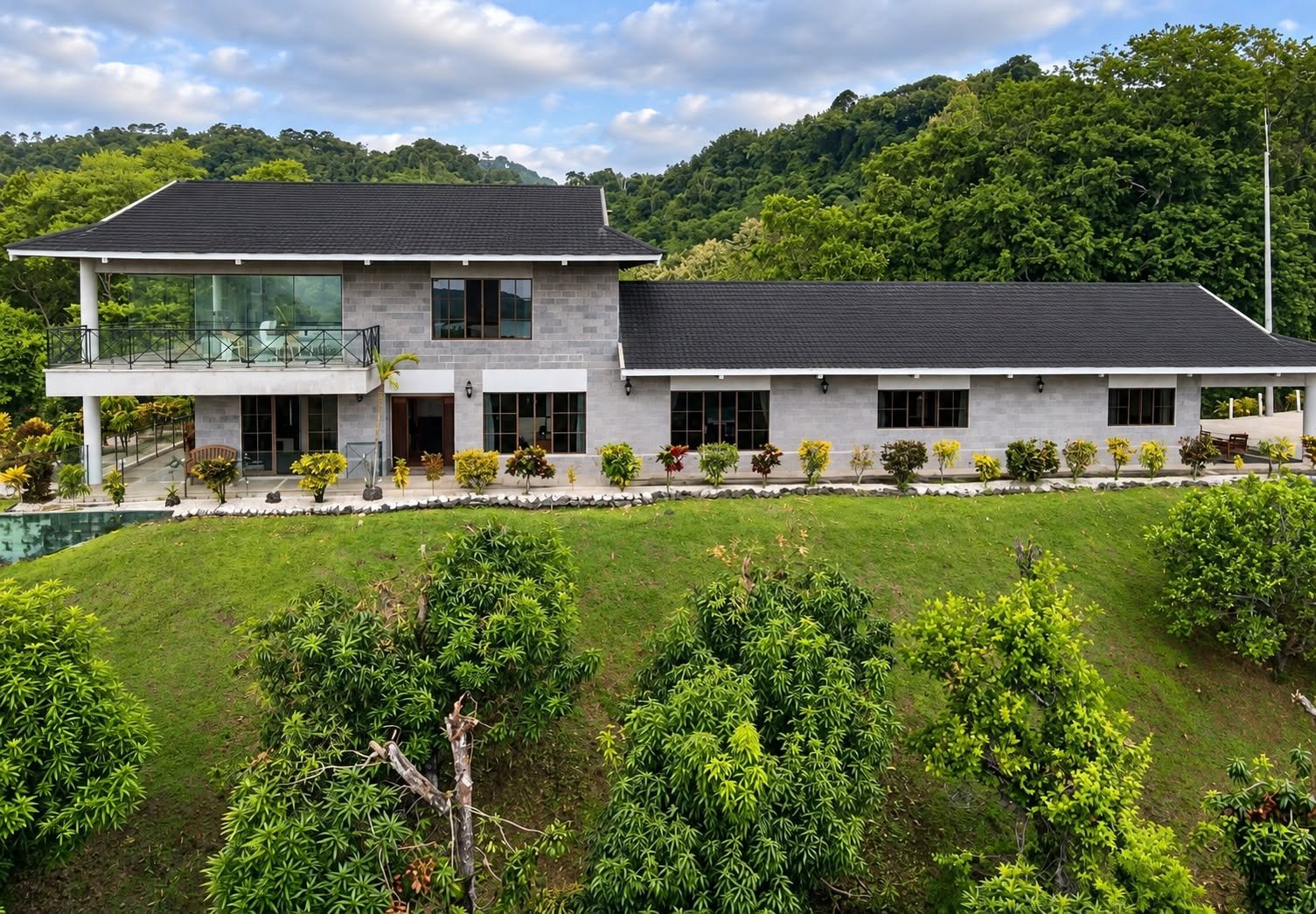 Exterior of Finca Pamela luxury residence with landscaped gardens and spacious covered veranda in Tambor