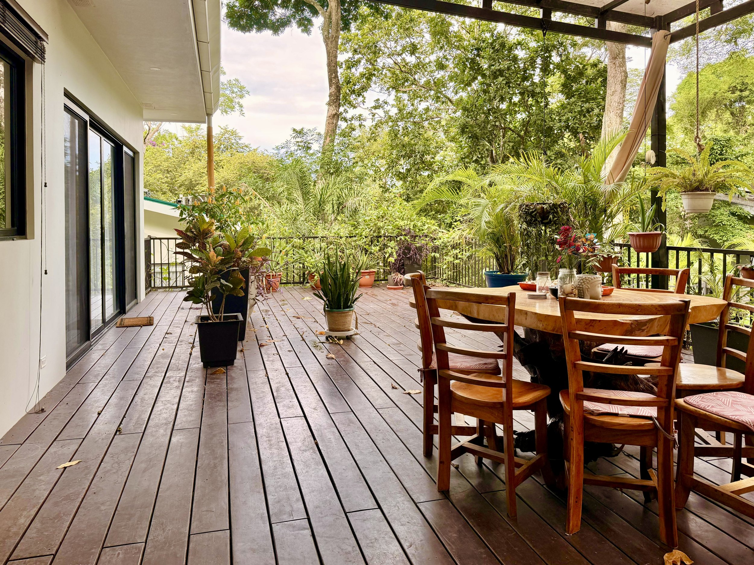 Casa Quantum outdoor dining and entertaining deck overlooking lush tropical greenery in Paquera, Costa Rica.