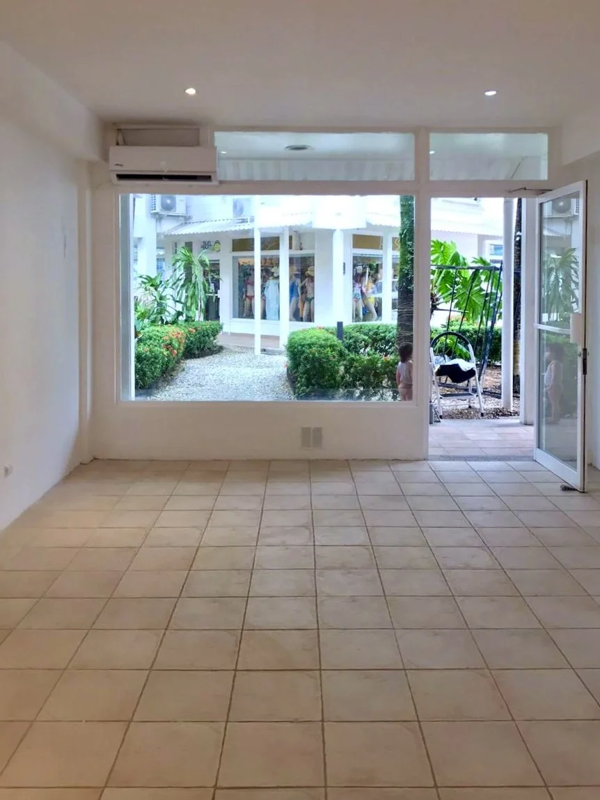 Interior view of Santa Teresa retail unit with glass entrance and tiled flooring