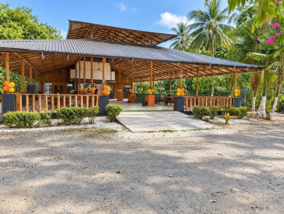 Exterior of tropical restaurant and bar with covered outdoor dining in Tambor, Costa Rica.