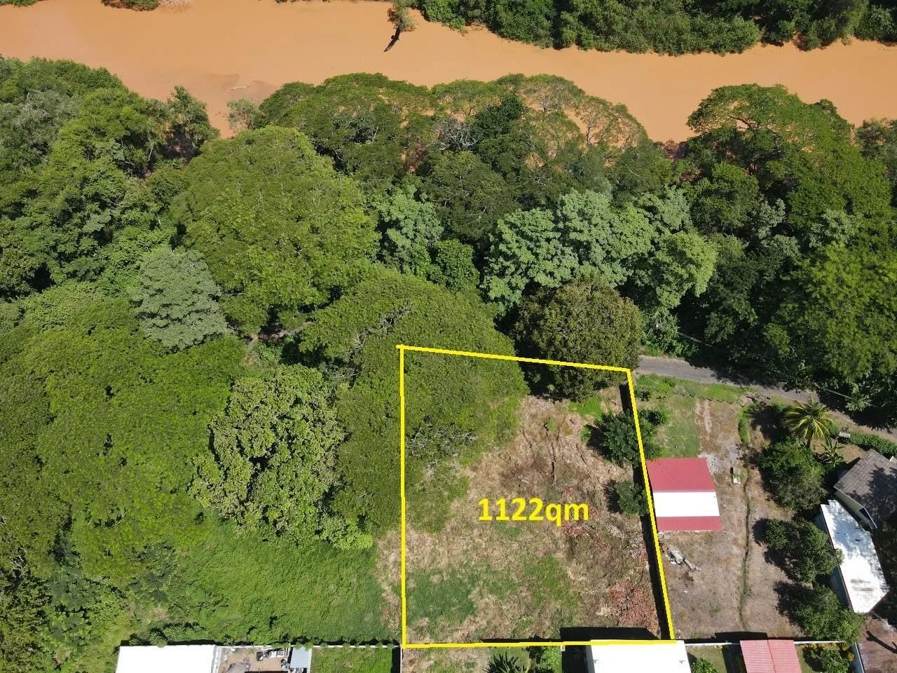 Aerial view of 1,122 square meter building lot outlined in yellow near Tambor Beach, Costa Rica.