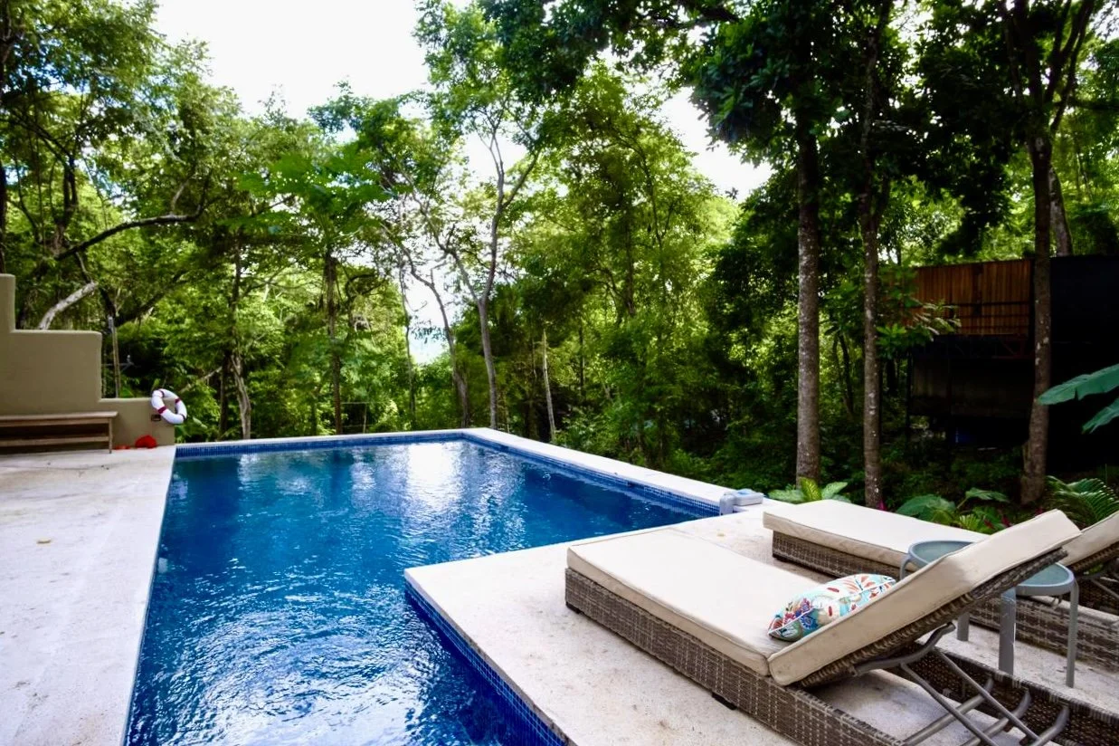 Private saltwater pool with sun loungers overlooking lush tropical forest at House of Light near Playa Órganos, Costa Rica