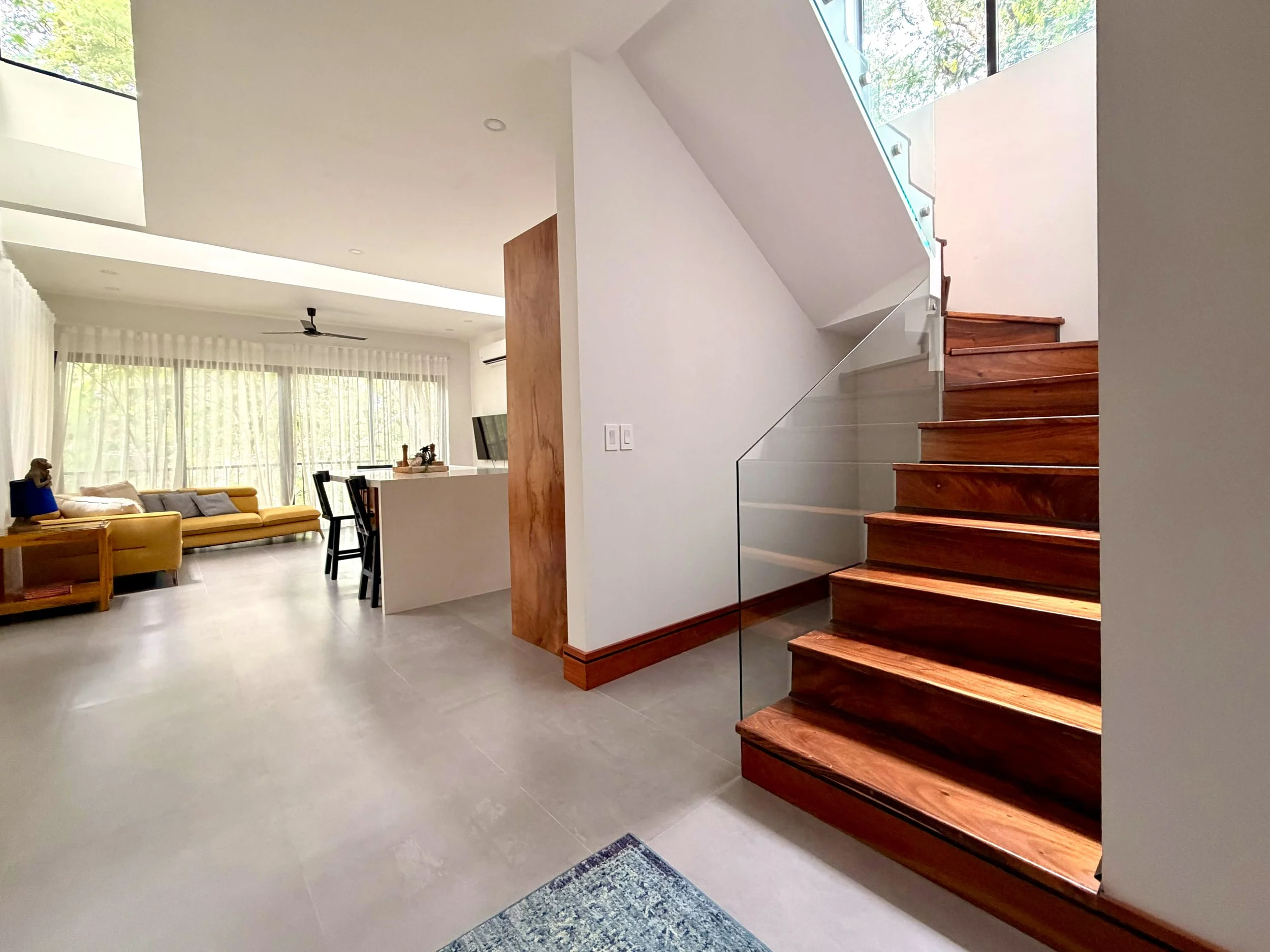 Casa Colina interior wooden staircase connecting the two levels of this contemporary home in Paquera, Costa Rica.