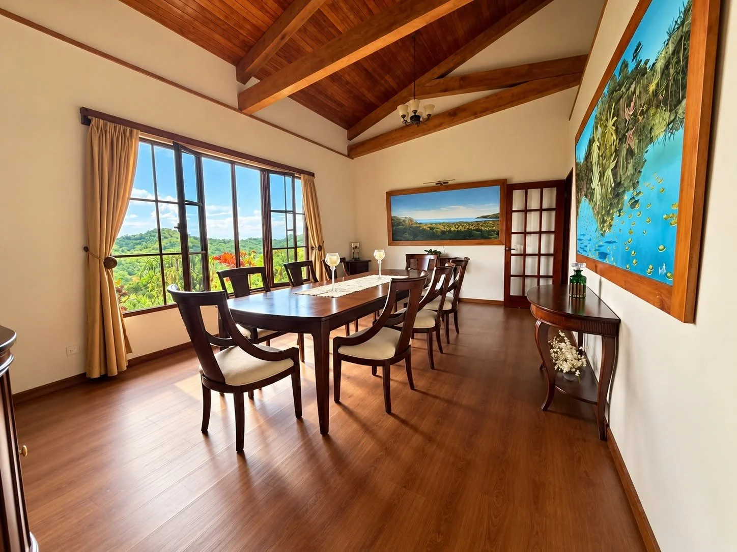 Formal dining room with large windows overlooking the tropical landscape at Finca Pamela