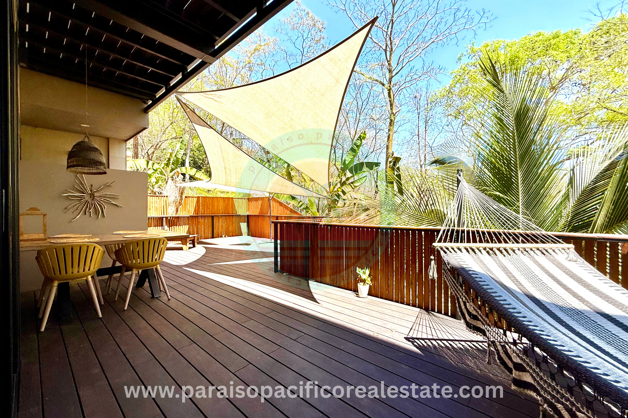 Outdoor dining and hammock on patio at Buddha House Organos near the beach in Costa Rica