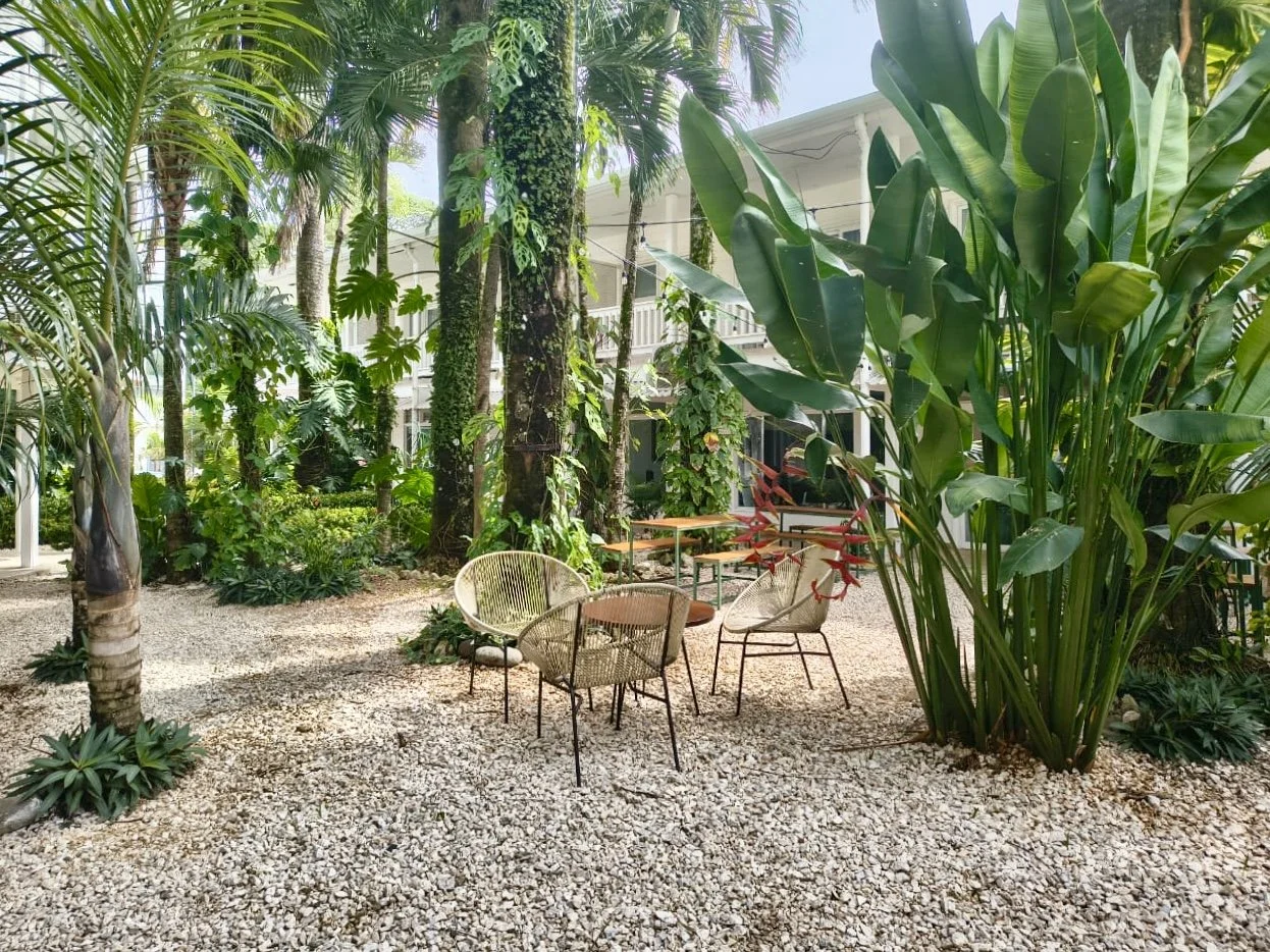 Tropical garden courtyard with outdoor seating at Plaza Playa Carmen, Costa Rica
