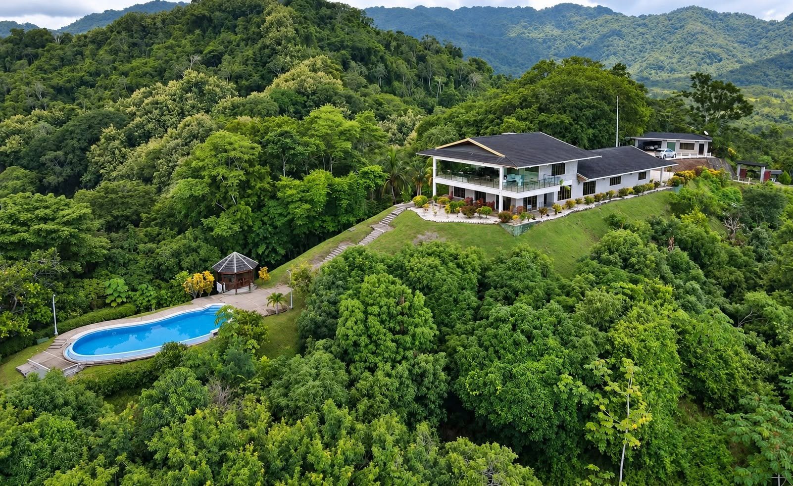 Aerial view of Finca Pamela luxury estate and swimming pool surrounded by jungle in Tambor, Costa Rica