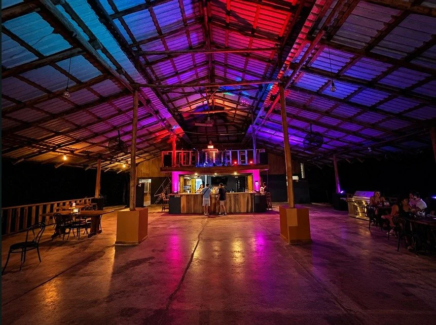 Spacious covered entertainment venue with colorful lighting for private events and gatherings in Tambor.