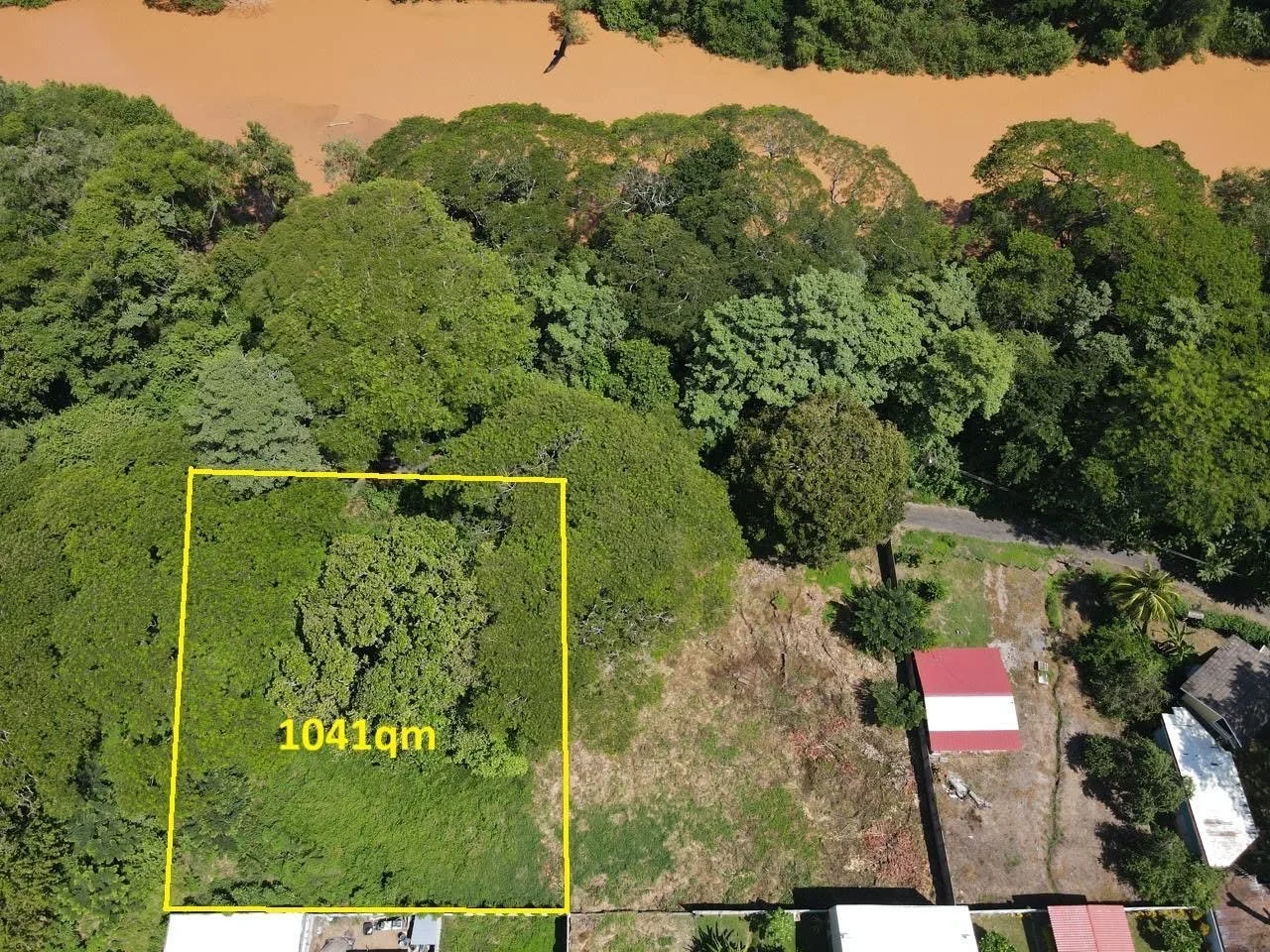 Aerial view of adjacent 1,041 square meter lot outlined in yellow for sale in Tambor, Costa Rica.