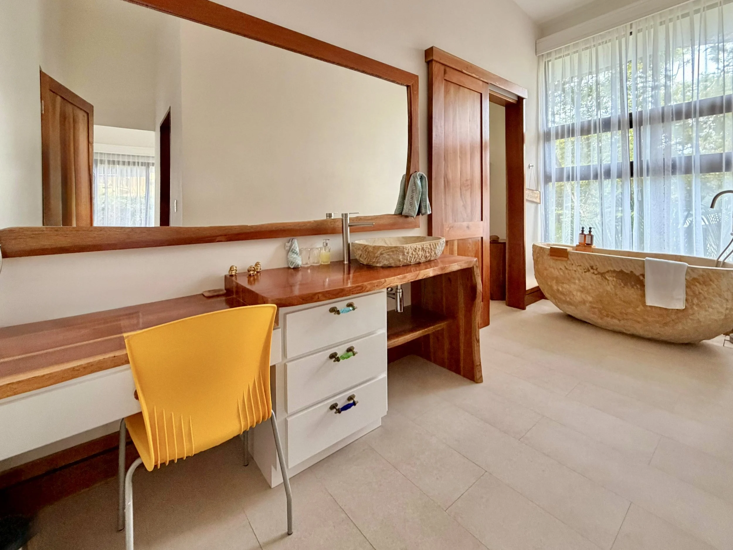 Casa Quantum bedroom vanity area with large wooden-framed mirror, dressing table and natural wood finishes.