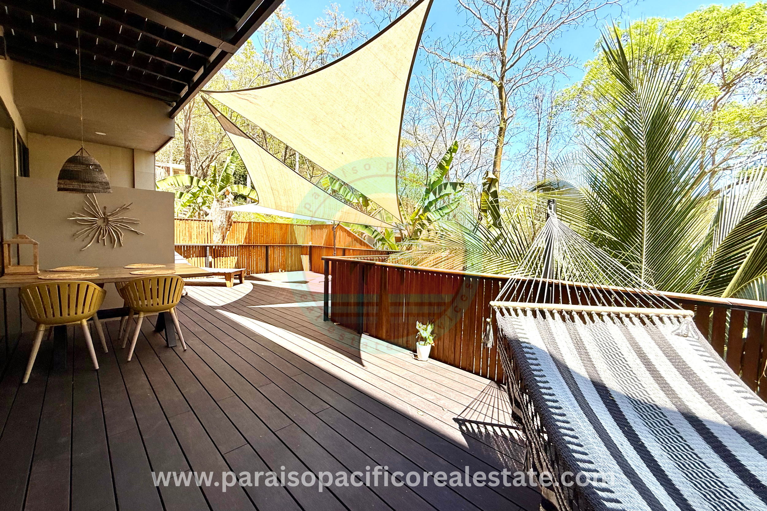 Outdoor patio dining and hammock area at Buddha House Organos near the beach in Costa Rica