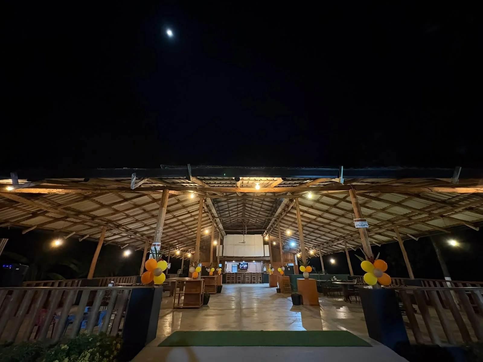 Covered restaurant and event venue illuminated at night in Tambor, Costa Rica.