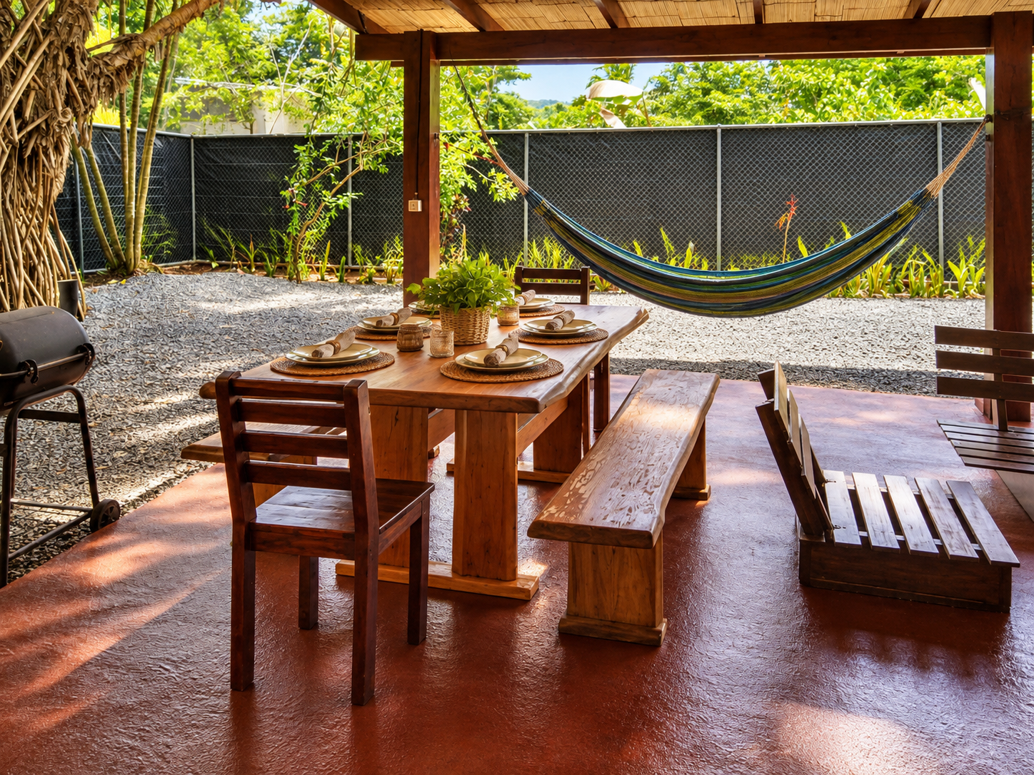 Covered outdoor dining rancho with hardwood table, benches and hammock at Casa Palma Bonita