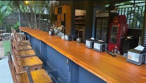 Wooden service counter and bar equipment inside Tambor restaurant and hospitality business.