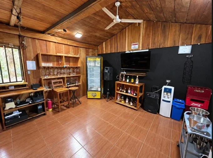 Wood-paneled indoor space with television and sound equipment at Tambor restaurant and bar.