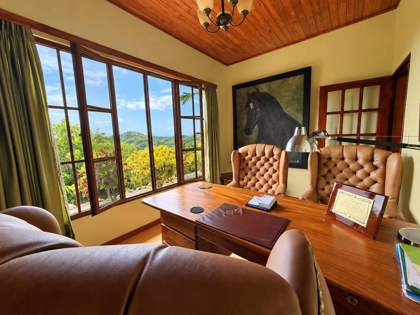 Private home office with large windows overlooking the tropical hills of Tambor, Costa Rica