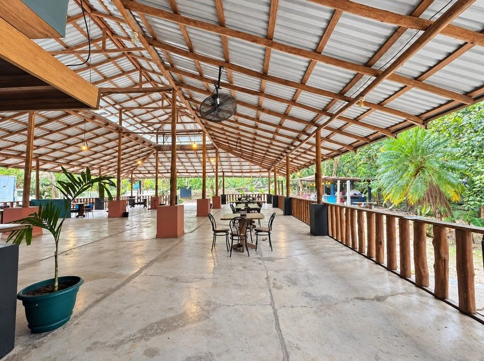 Large covered open-air restaurant dining area with tropical surroundings in Tambor, Costa Rica.