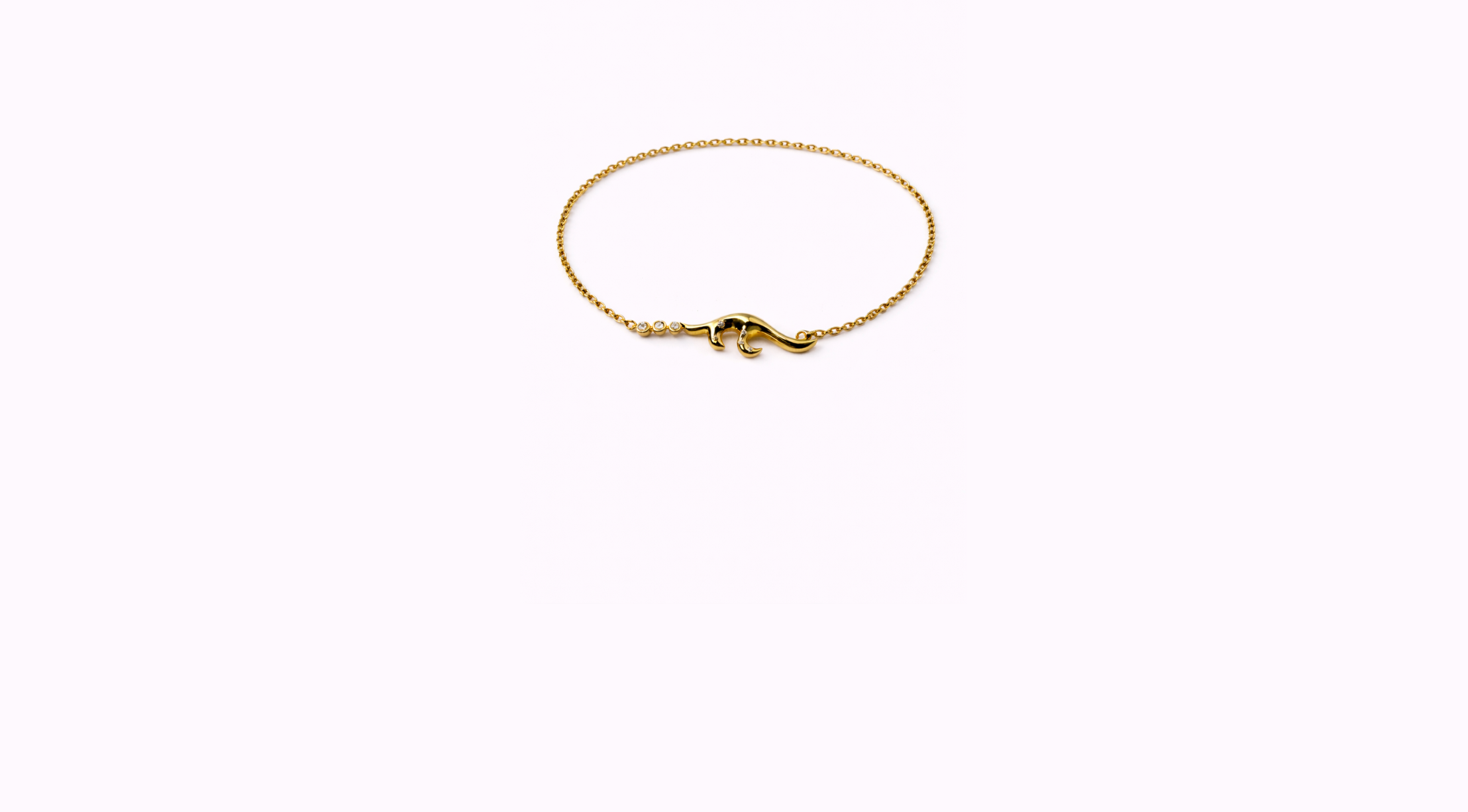 Gold necklace with a dolphin-shaped pendant, displayed on a plain white background.