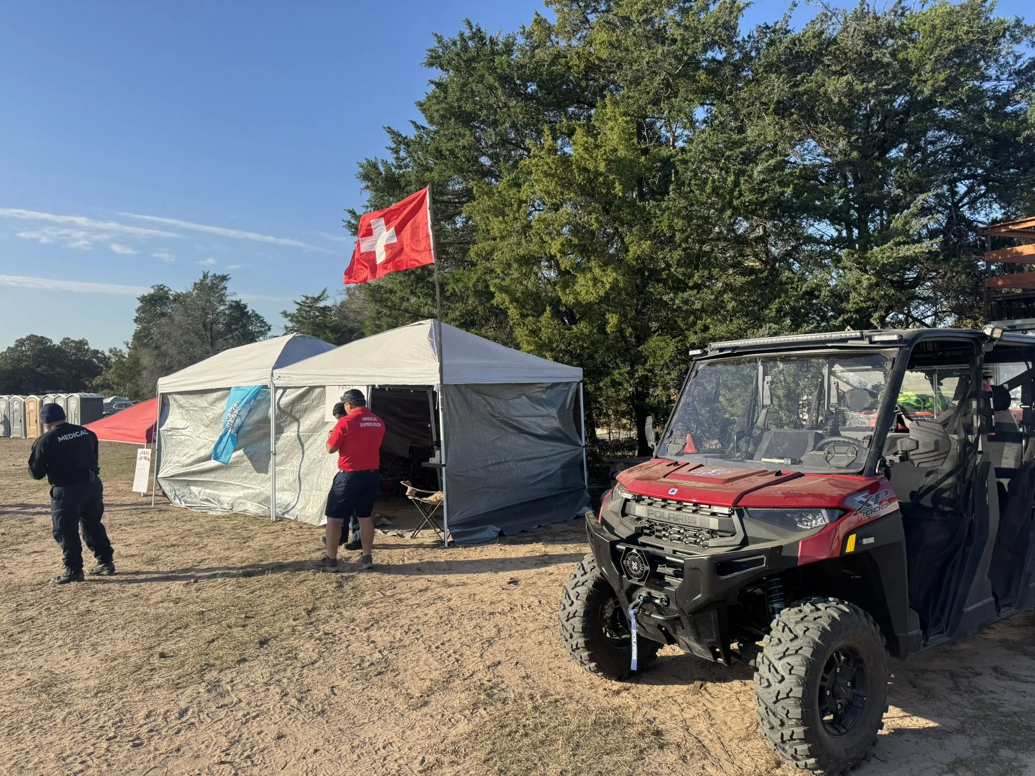 Event medical services with EMTs and paramedics staffing a medical tent and rapid-response UTV at a large outdoor festival in Texas
