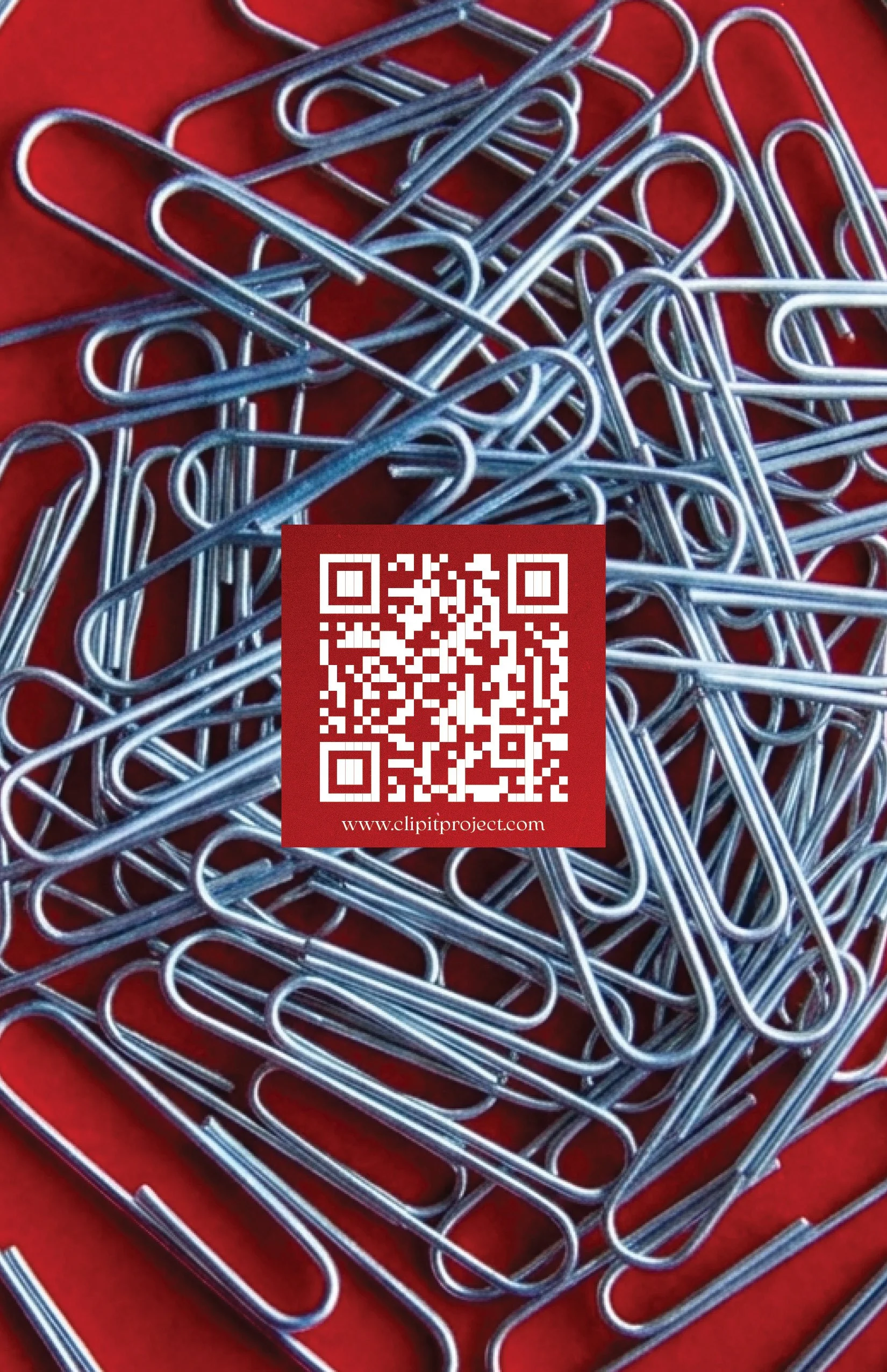 A collection of silver paper clips scattered on a red surface, with a QR code and the website www.clipitproject.com displayed on a red square in the center of the image.