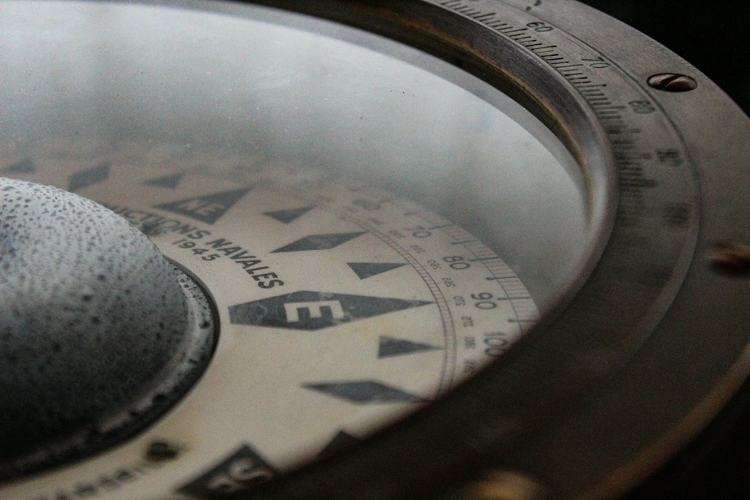 Close-up of a calibration wheel with numbered markings, the wheel appears to be on a measurement device, with a speckled gray object in the foreground.