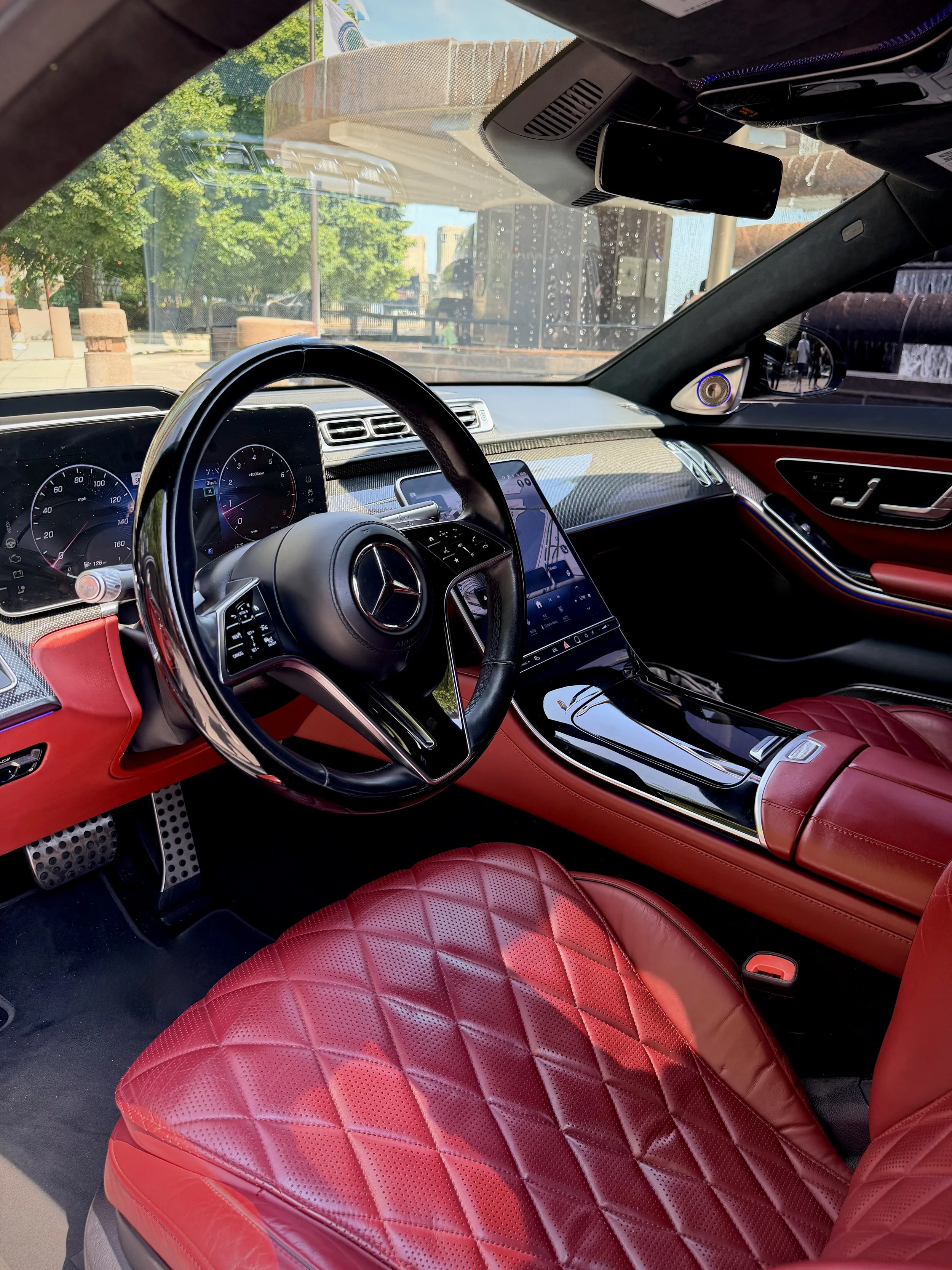 Matte Graphite Gray Mercedes-Benz S580 luxury sedan parked in downtown Chicago available for rental.