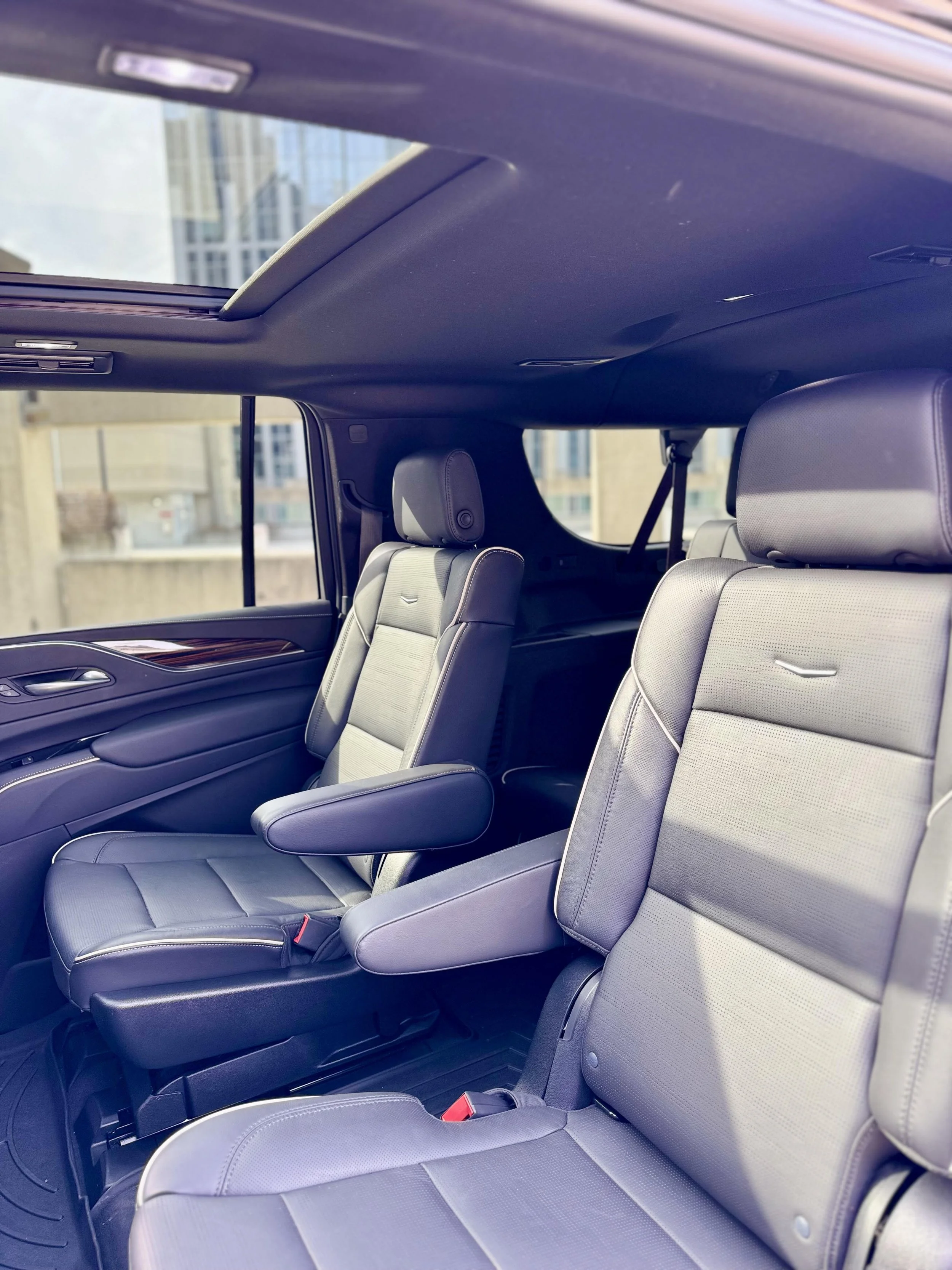 Luxury SUV interior with leather seats, armrests, and sunroof
