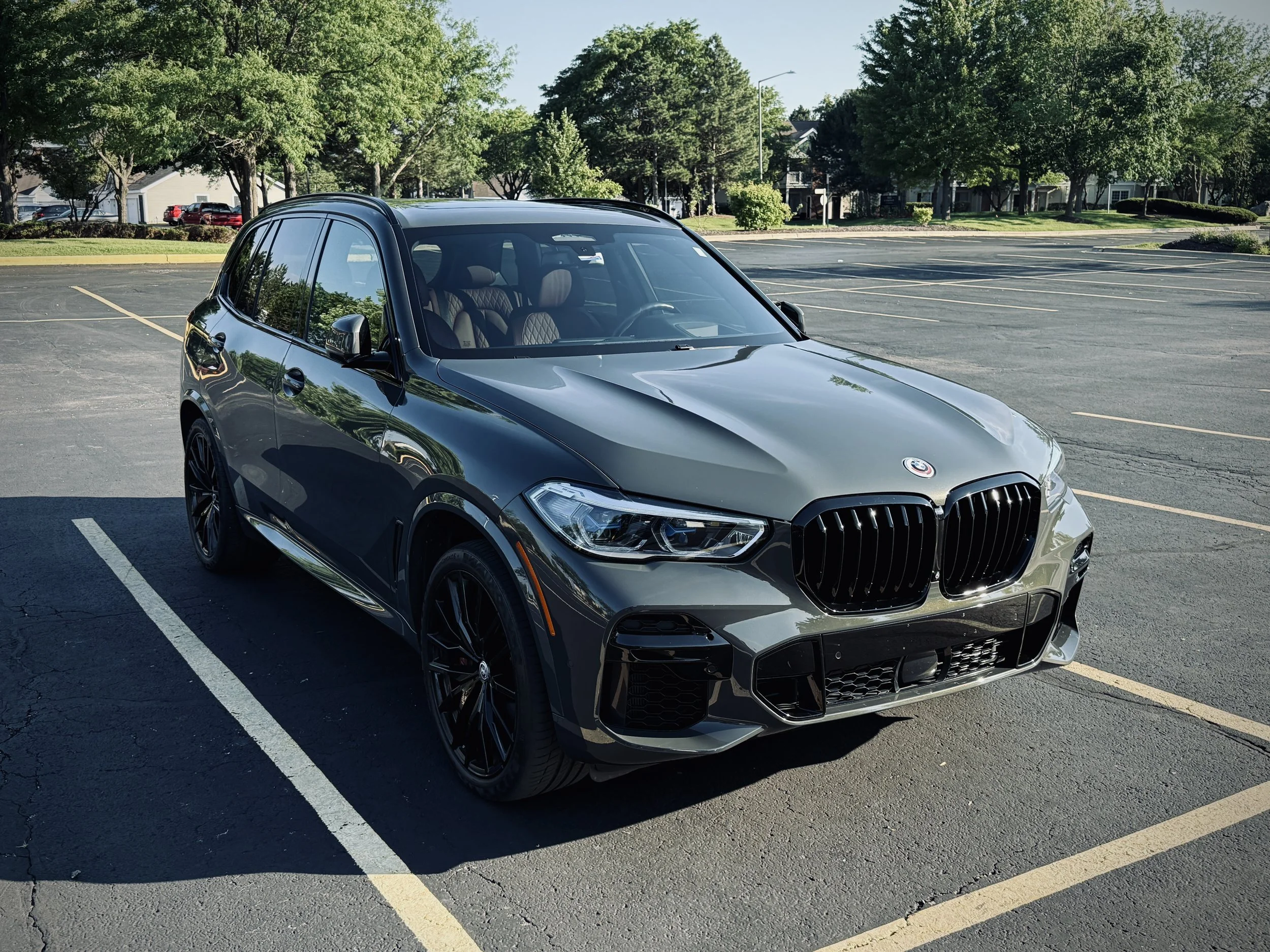 Nardo Gray BMW X5 M50i luxury SUV parked in Chicago featuring black wheels, aggressive styling, and a twin-turbo V8 engine.