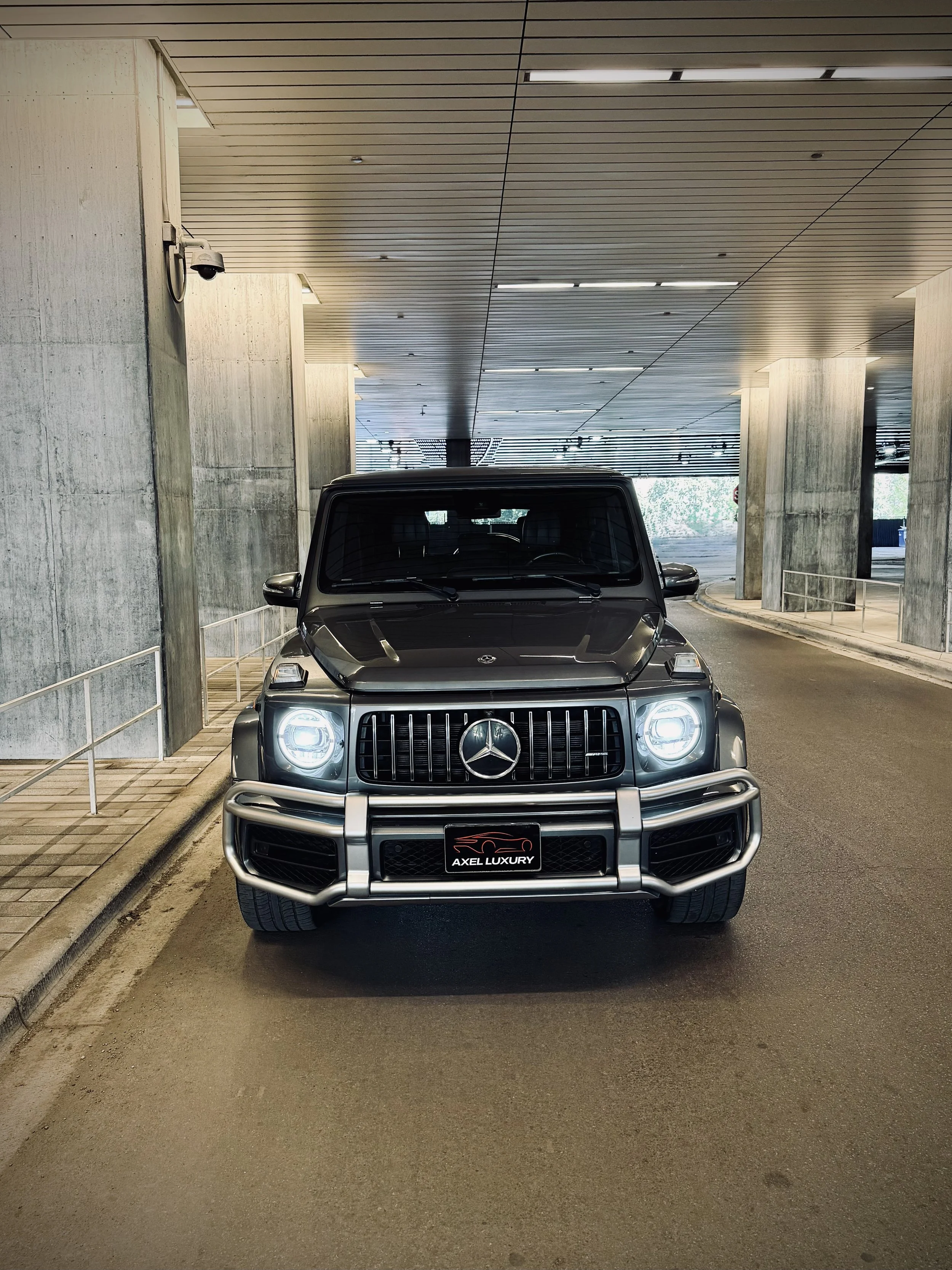 Graphite Metallic Gray Mercedes-Benz G63 AMG luxury SUV parked in Chicago available for rental through Axel Luxury.
