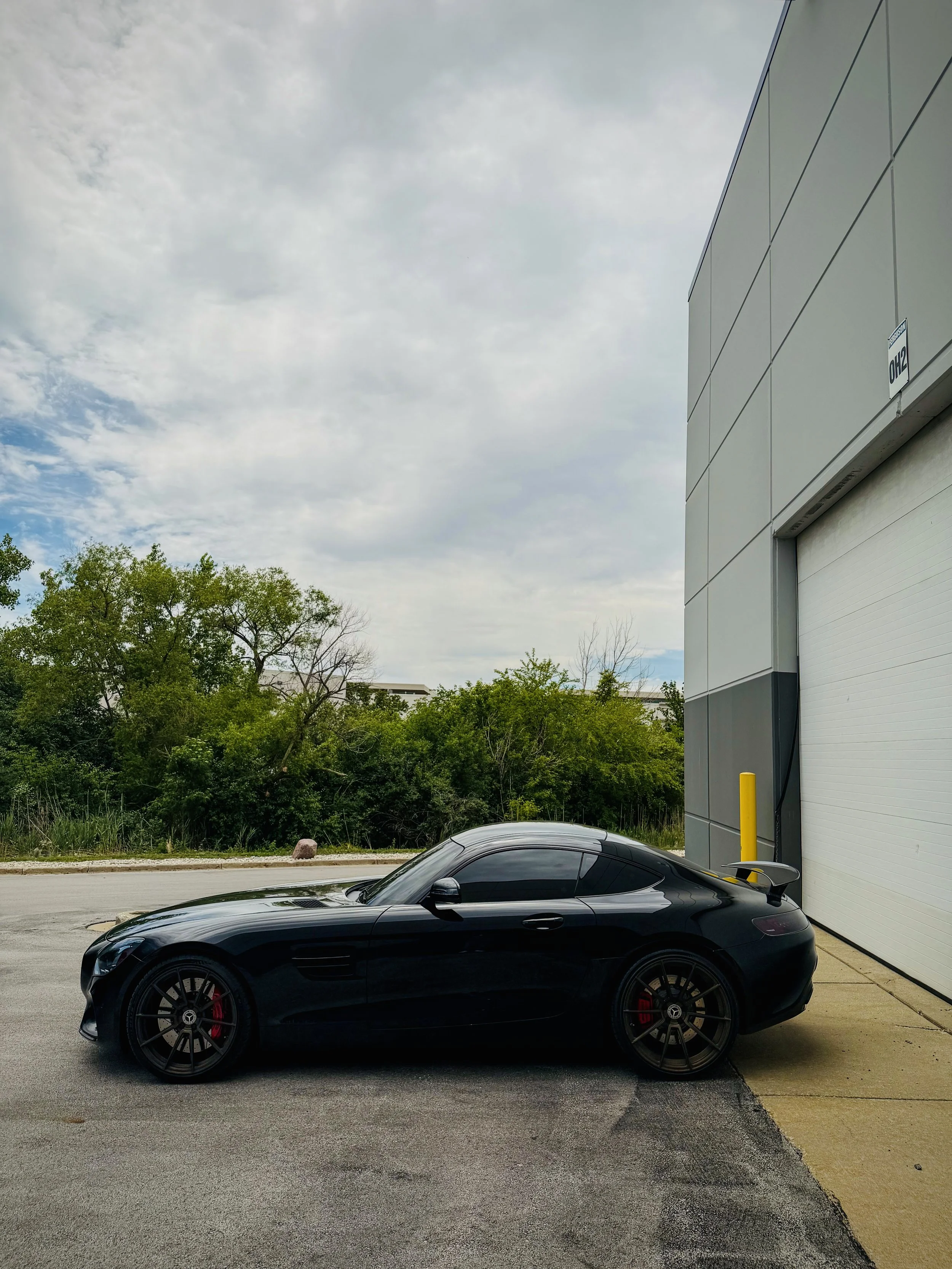 Black Mercedes-AMG GT S with a red leather interior available for rental in Chicago.