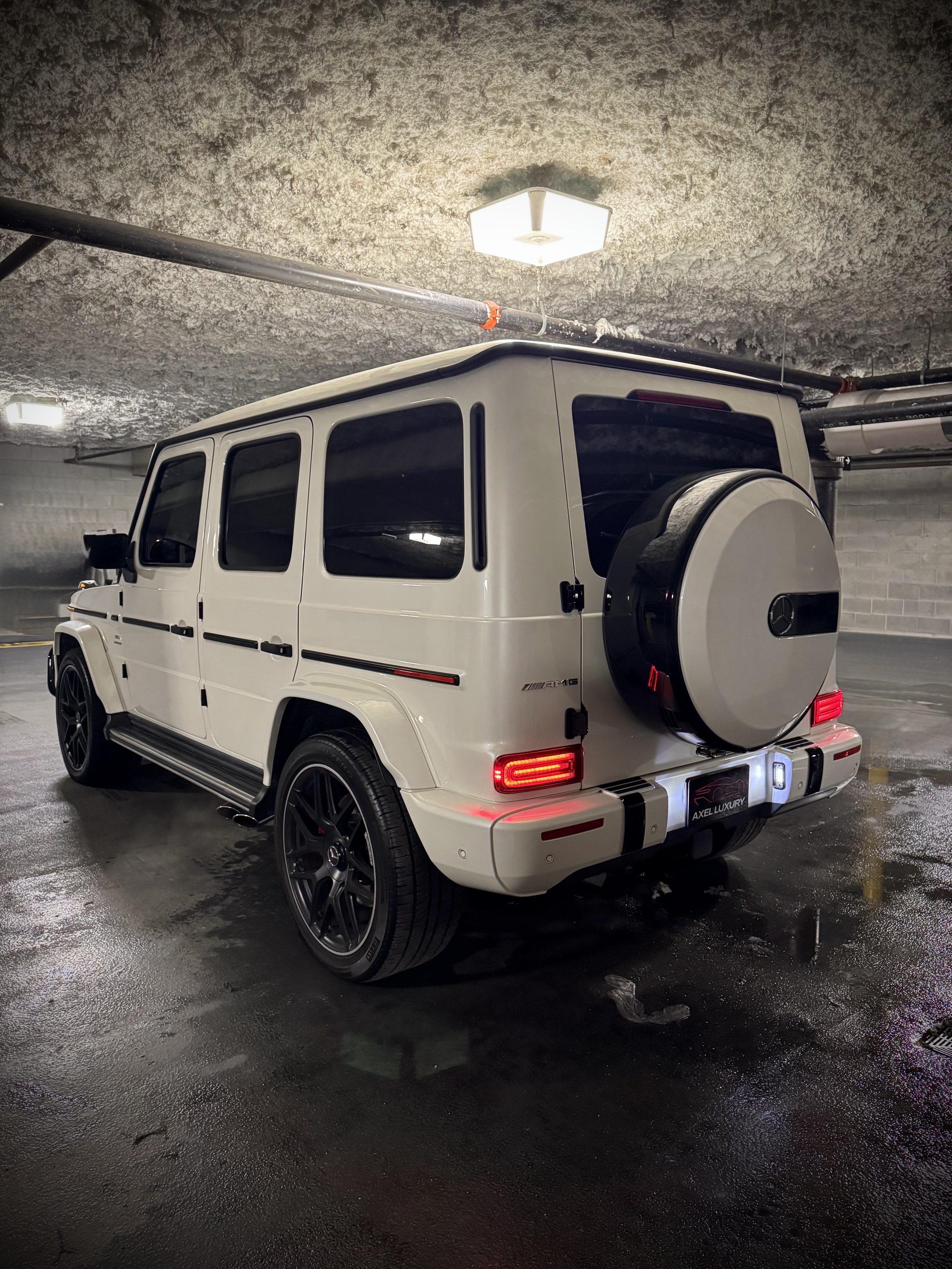 White Mercedes-AMG G63 with black interior, luxury SUV available for rental from Axel Luxury in Chicago.
