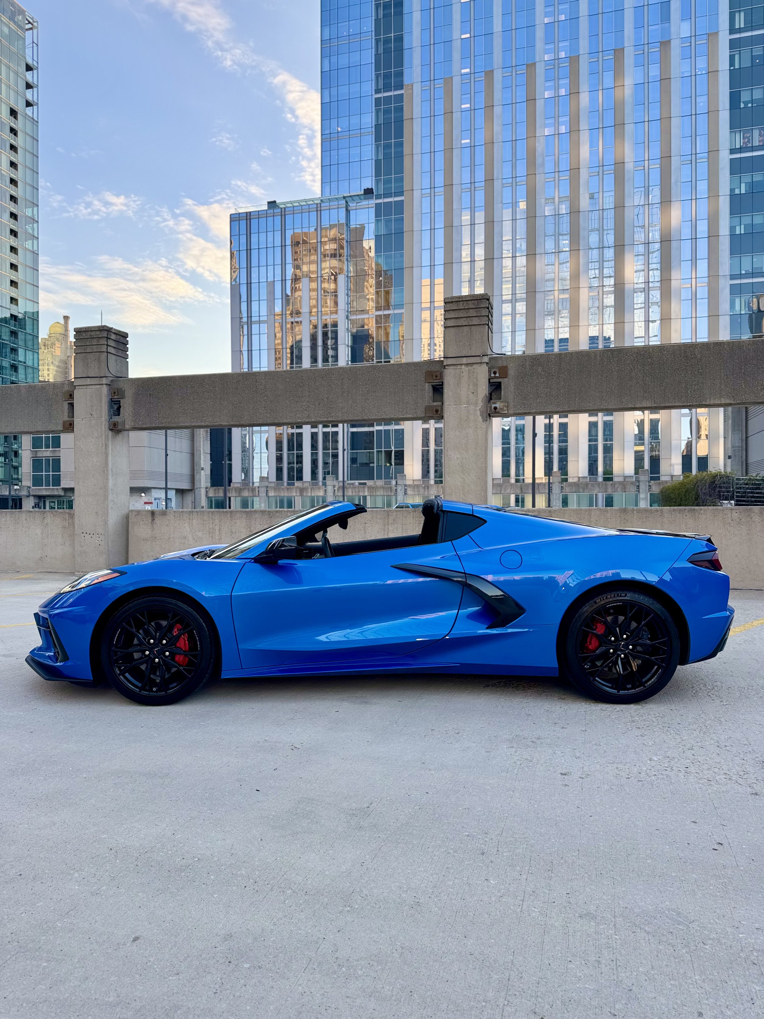Blue Chevrolet Corvette Stingray parked in Chicago, available for luxury sports car rental from Axel Luxury.