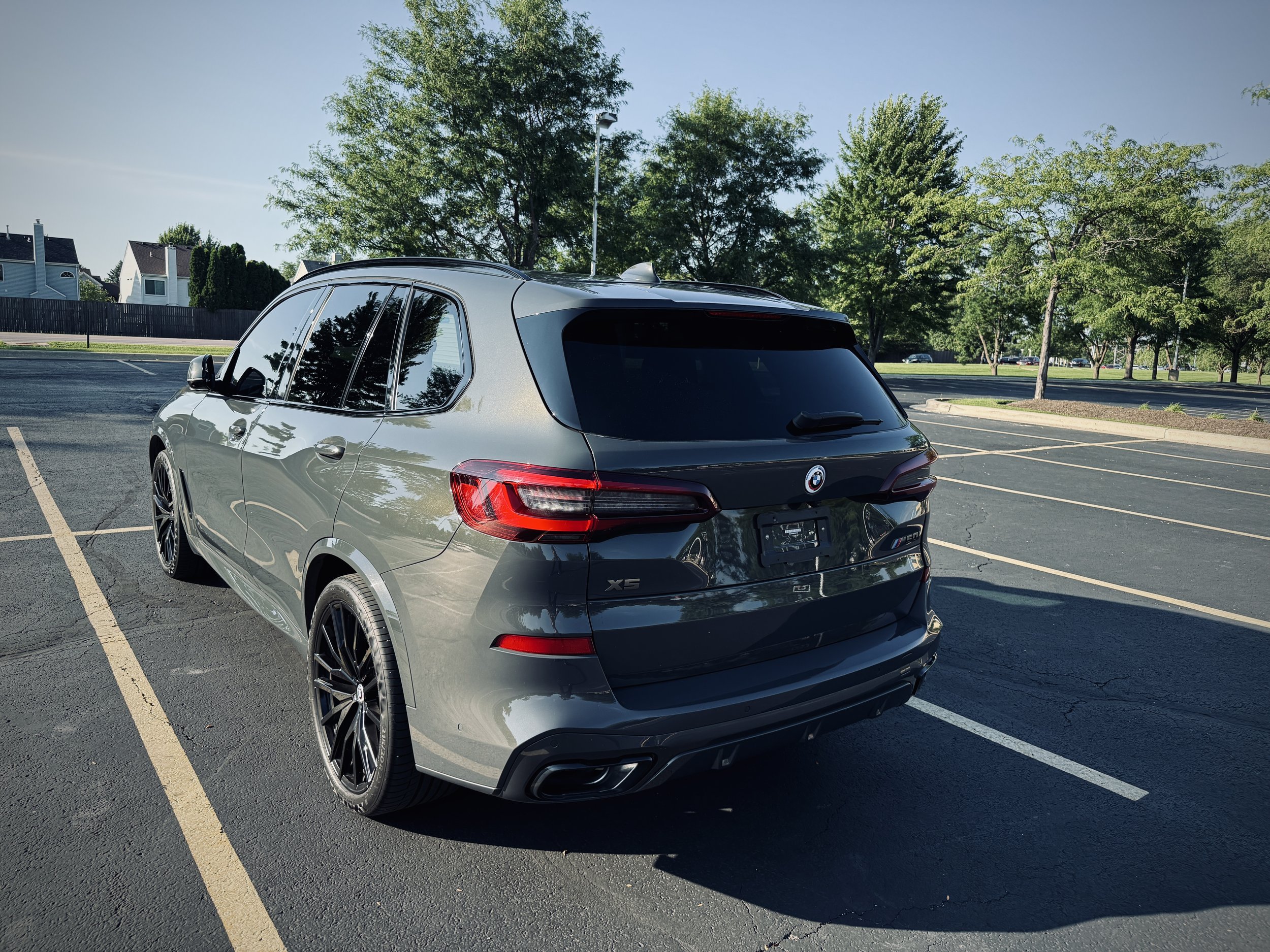 Nardo Gray BMW X5 M50i luxury SUV parked in Chicago featuring black wheels, aggressive styling, and a twin-turbo V8 engine.