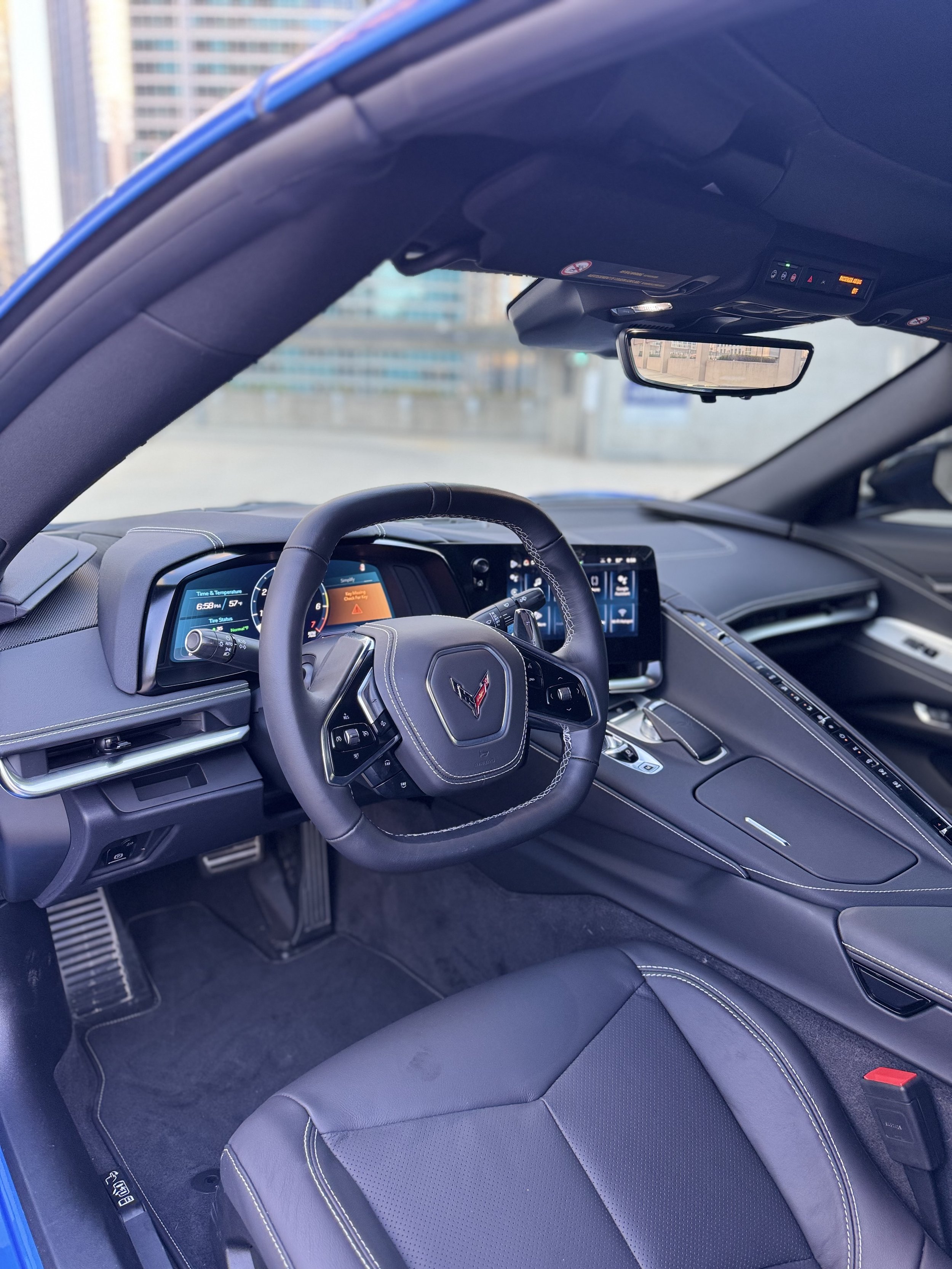 Blue Chevrolet Corvette Stingray parked in Chicago, available for luxury sports car rental from Axel Luxury.