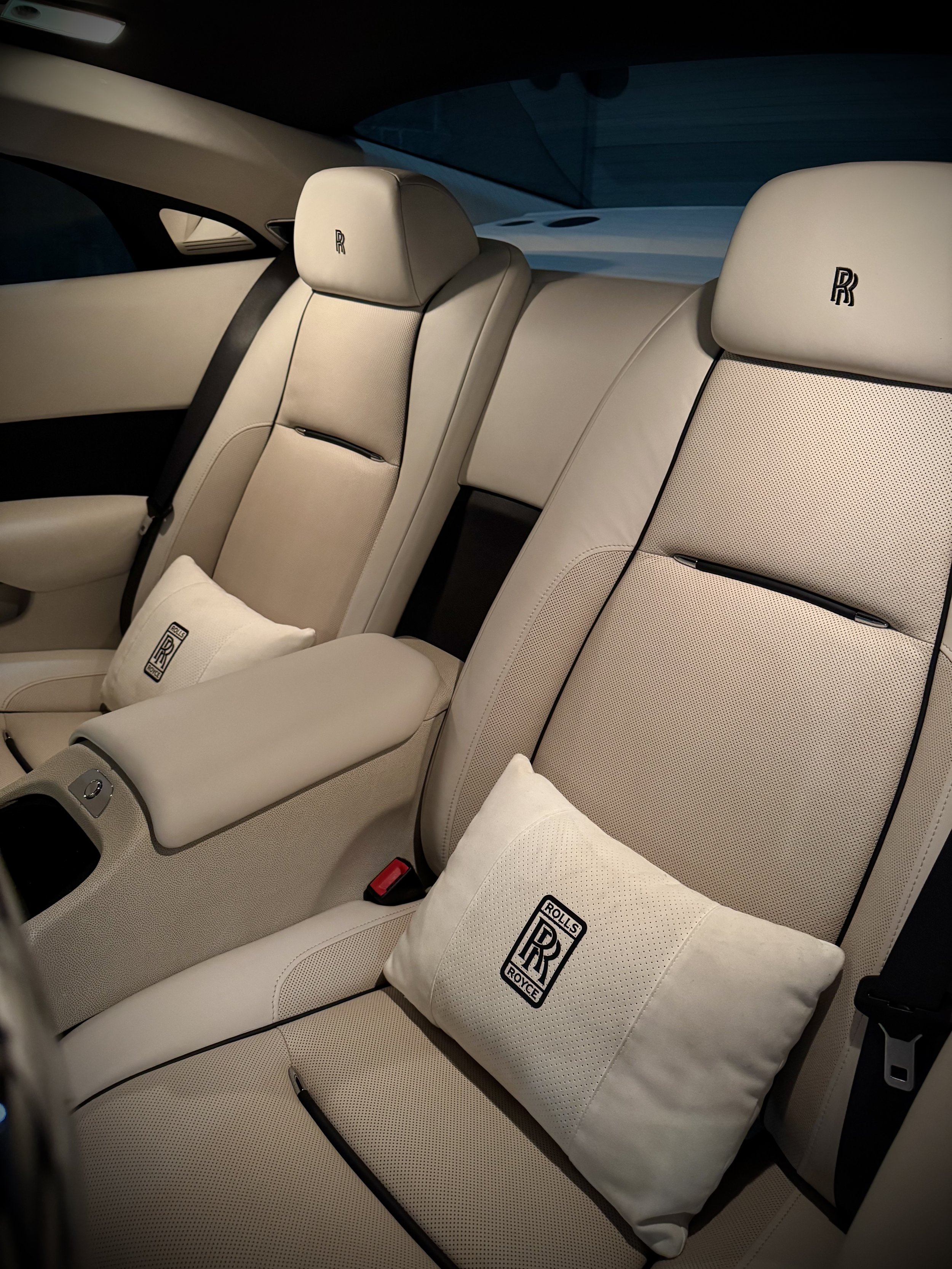 White Rolls-Royce Wraith rental from Axel Luxury parked in downtown Chicago with luxury white-on-white styling.