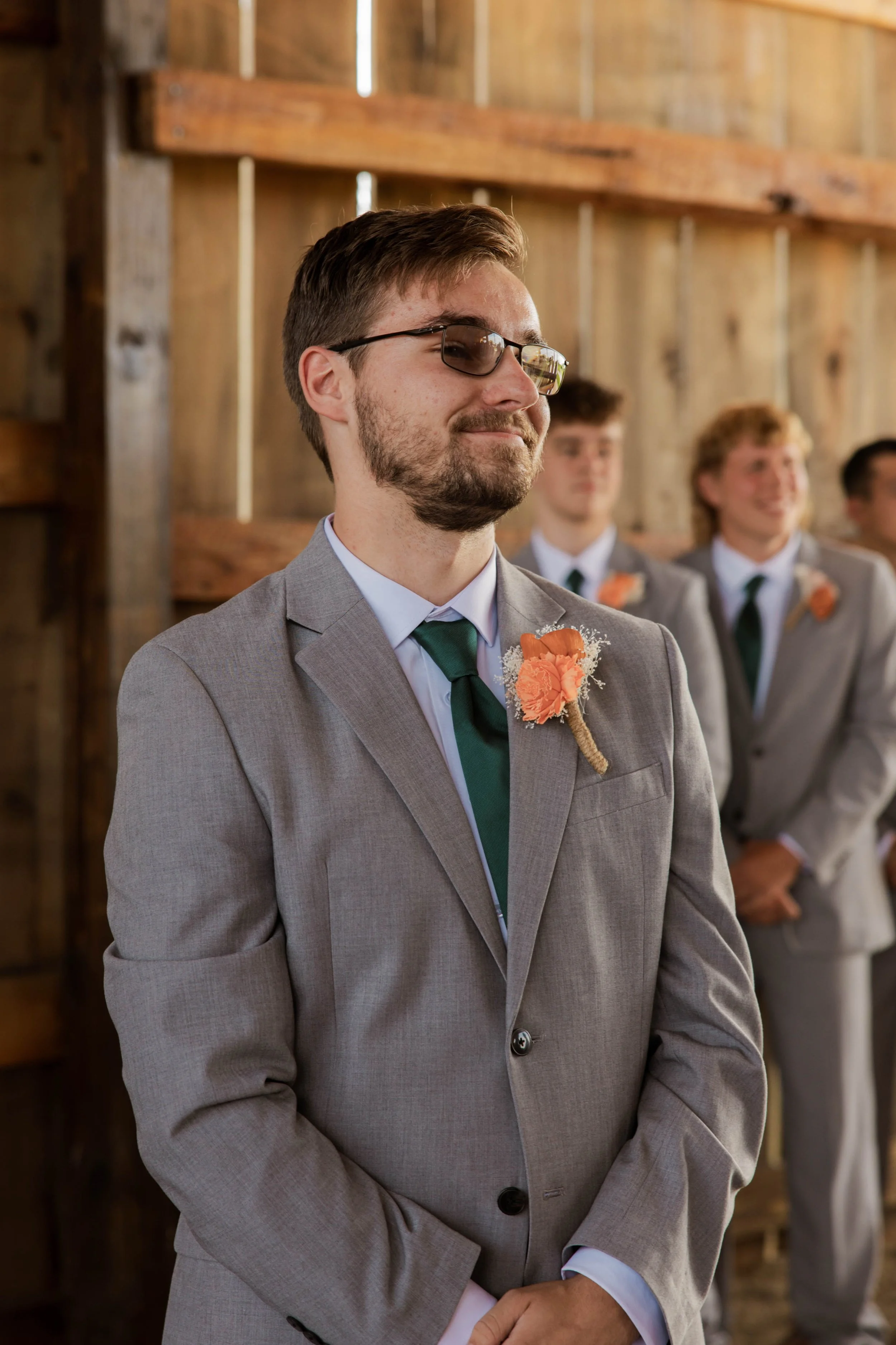 Wedding photography of a groom standing at the altar during a rustic indoor wedding ceremony, captured by a Florence, KY and destination wedding photographer.